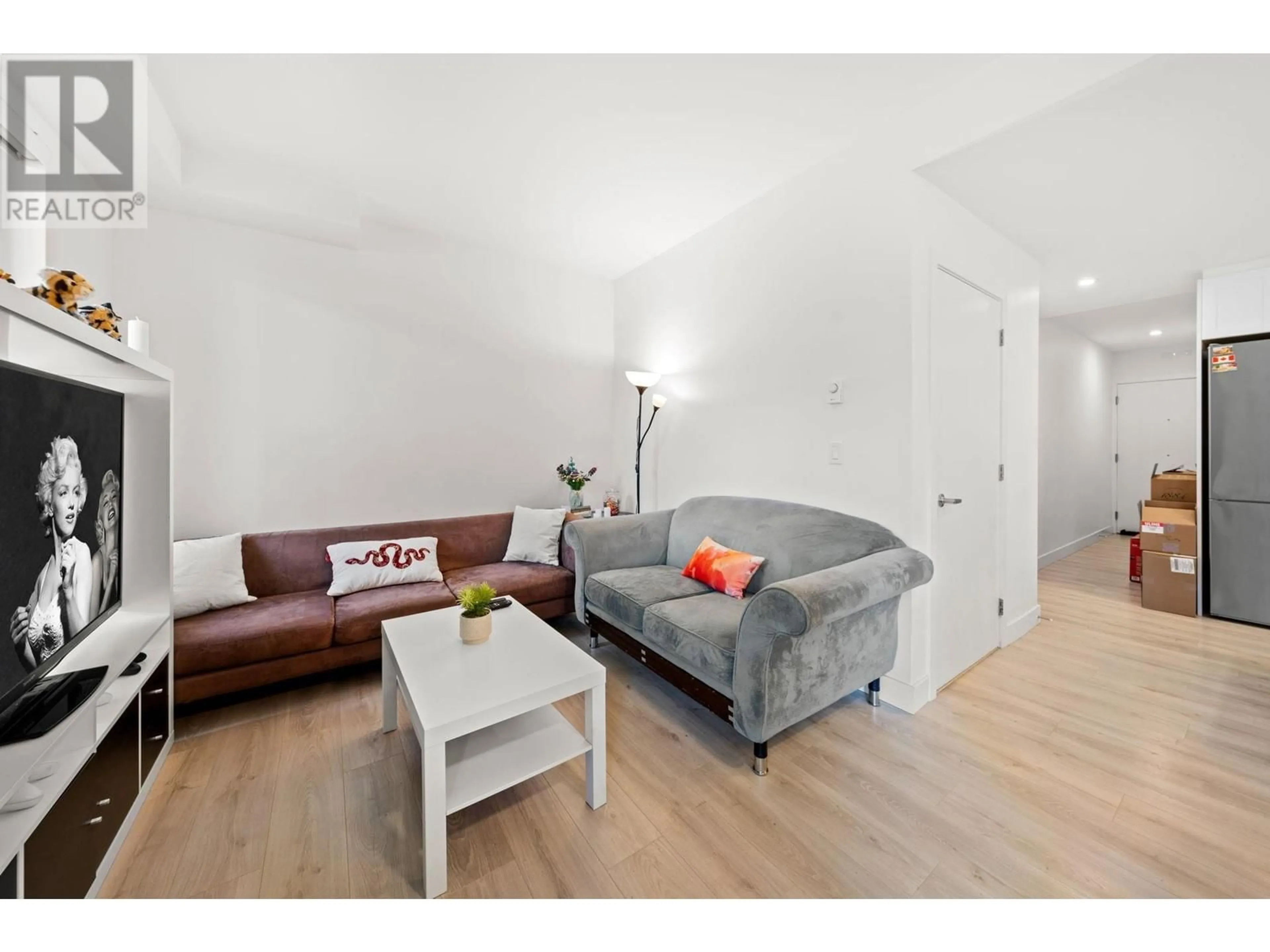 Living room with furniture, wood/laminate floor for 105 - 2688 DUKE STREET, Vancouver British Columbia V5R4S9
