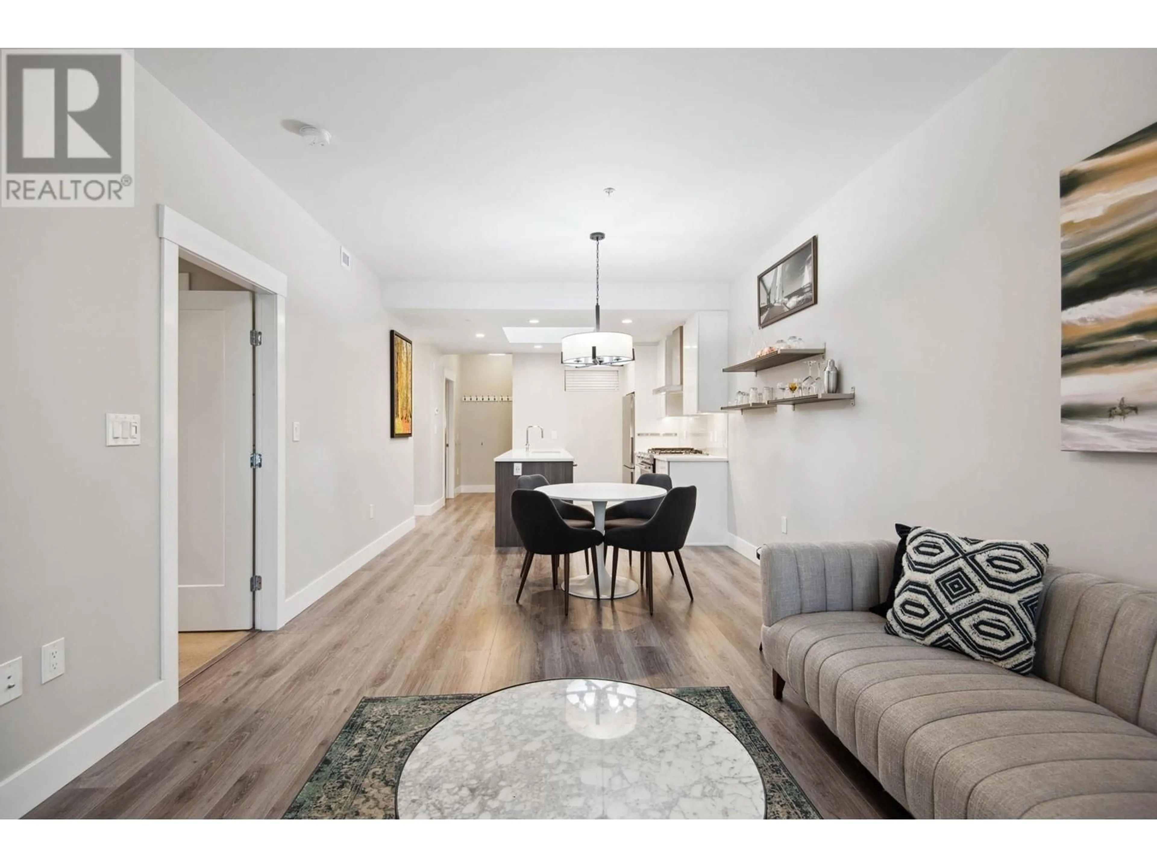Living room with furniture, wood/laminate floor for 603 - 1496 CHARLOTTE ROAD, North Vancouver British Columbia V7J0C9