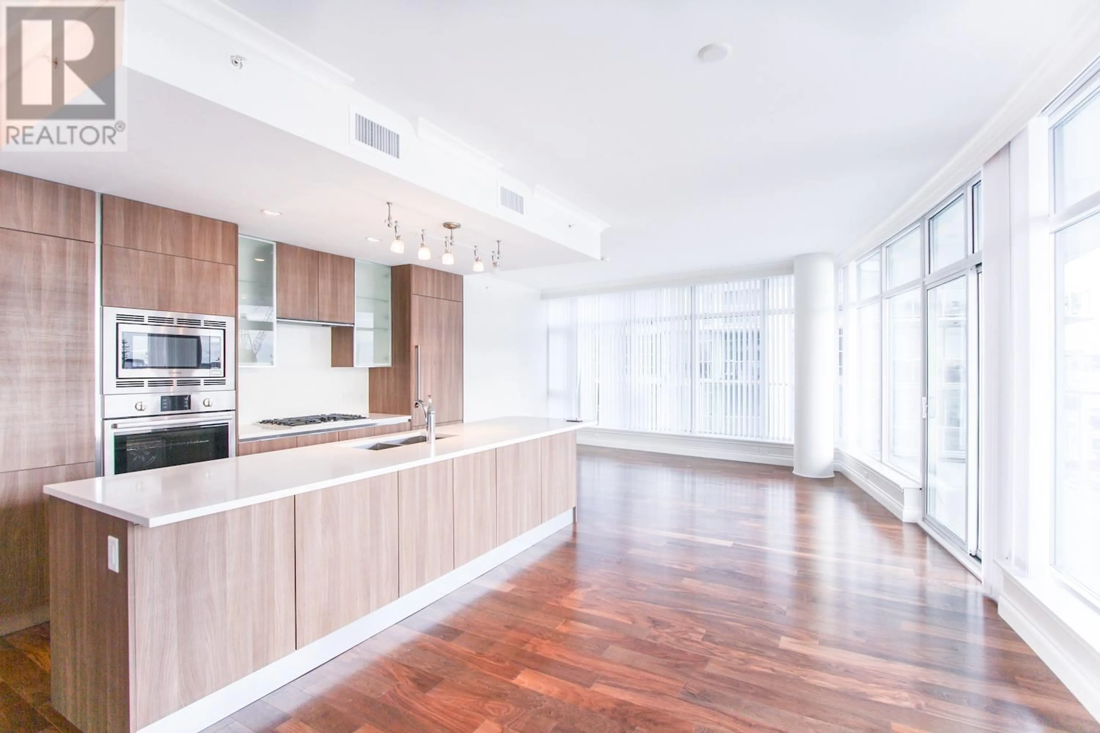 Open concept kitchen, wood/laminate floor for 701 - 185 VICTORY SHIP WAY, North Vancouver British Columbia V7L0G2