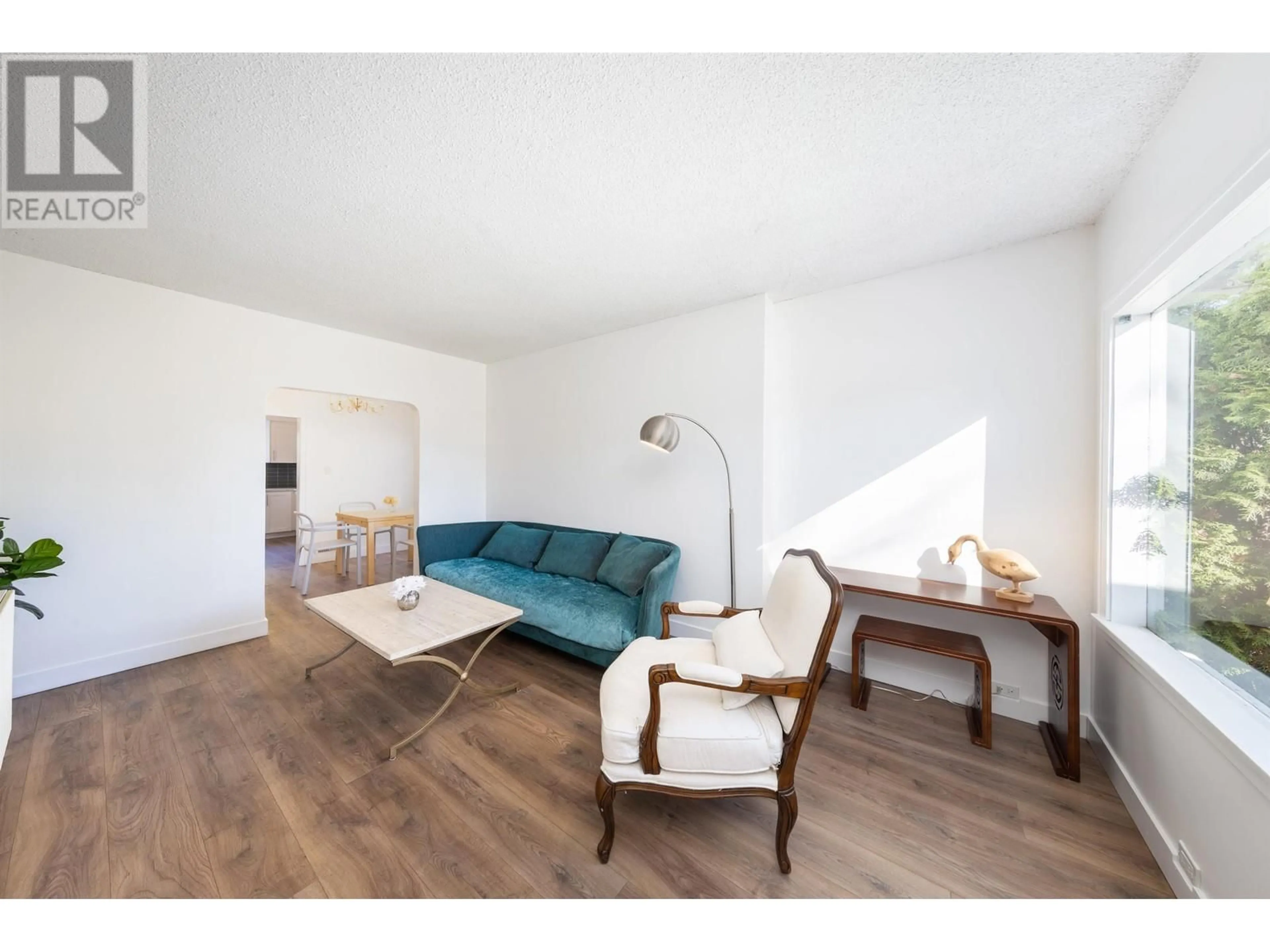 Living room with furniture, wood/laminate floor for 3405 W 24TH AVENUE, Vancouver British Columbia V6S1L3