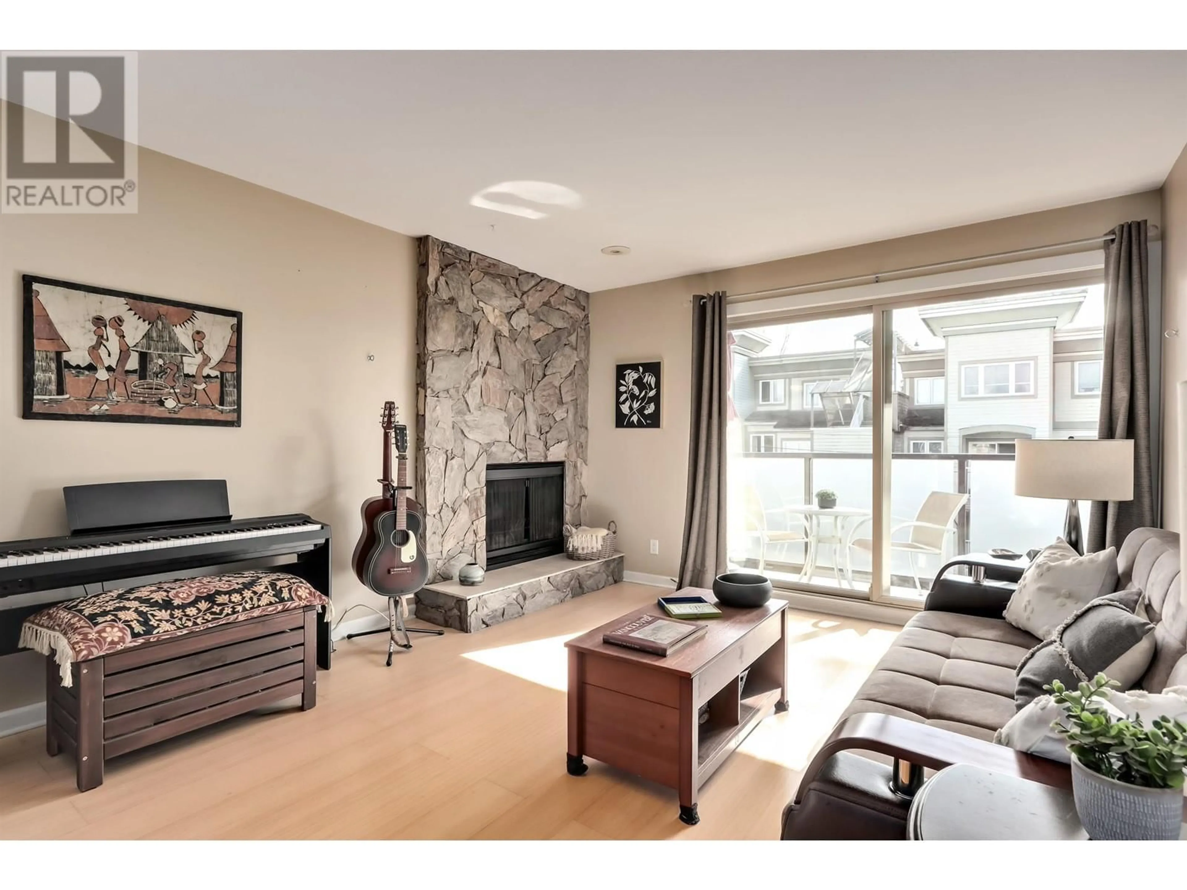 Living room with furniture, wood/laminate floor for 402 1864 FRANCES STREET, Vancouver British Columbia V5L1Z2