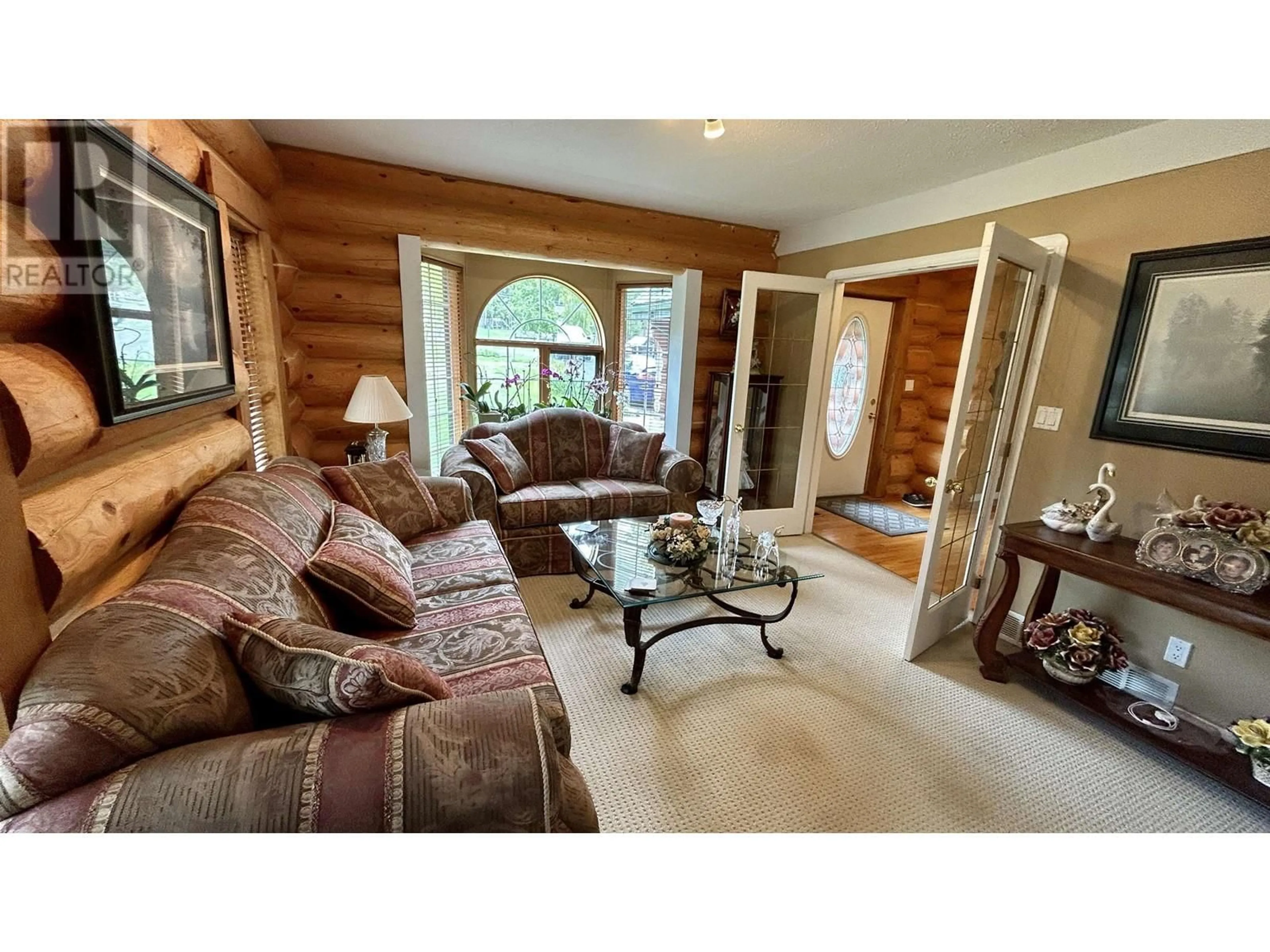 Living room with furniture, wood/laminate floor for 4906 KITWANGA DRIVE, 108 Mile Ranch British Columbia V0K2Z0