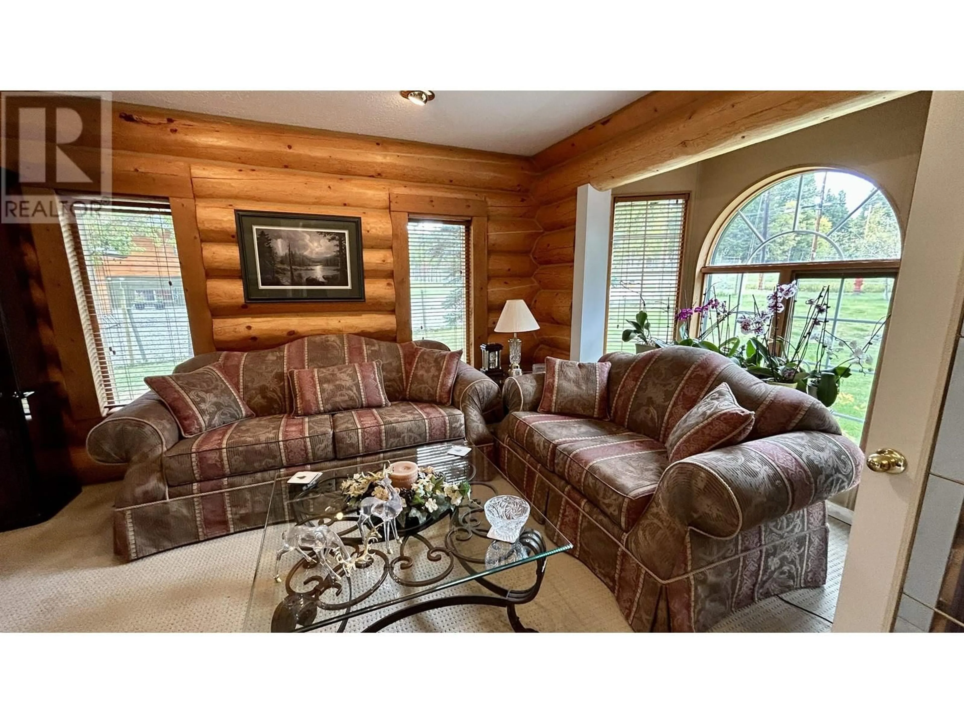 Living room with furniture, wood/laminate floor for 4906 KITWANGA DRIVE, 108 Mile Ranch British Columbia V0K2Z0