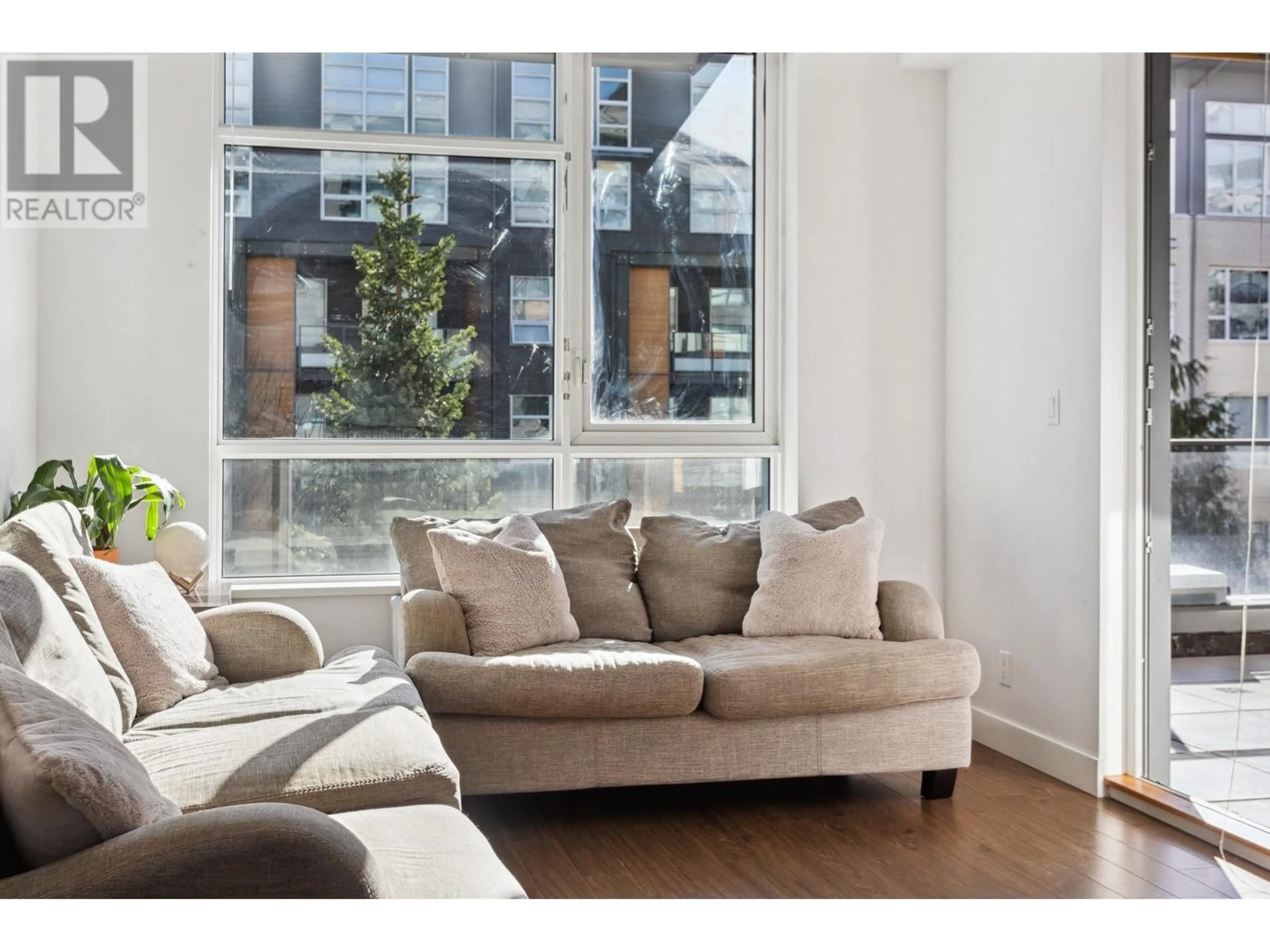 Living room with furniture, wood/laminate floor for 101 9150 UNIVERSITY HIGH STREET, Burnaby British Columbia V5A0C5