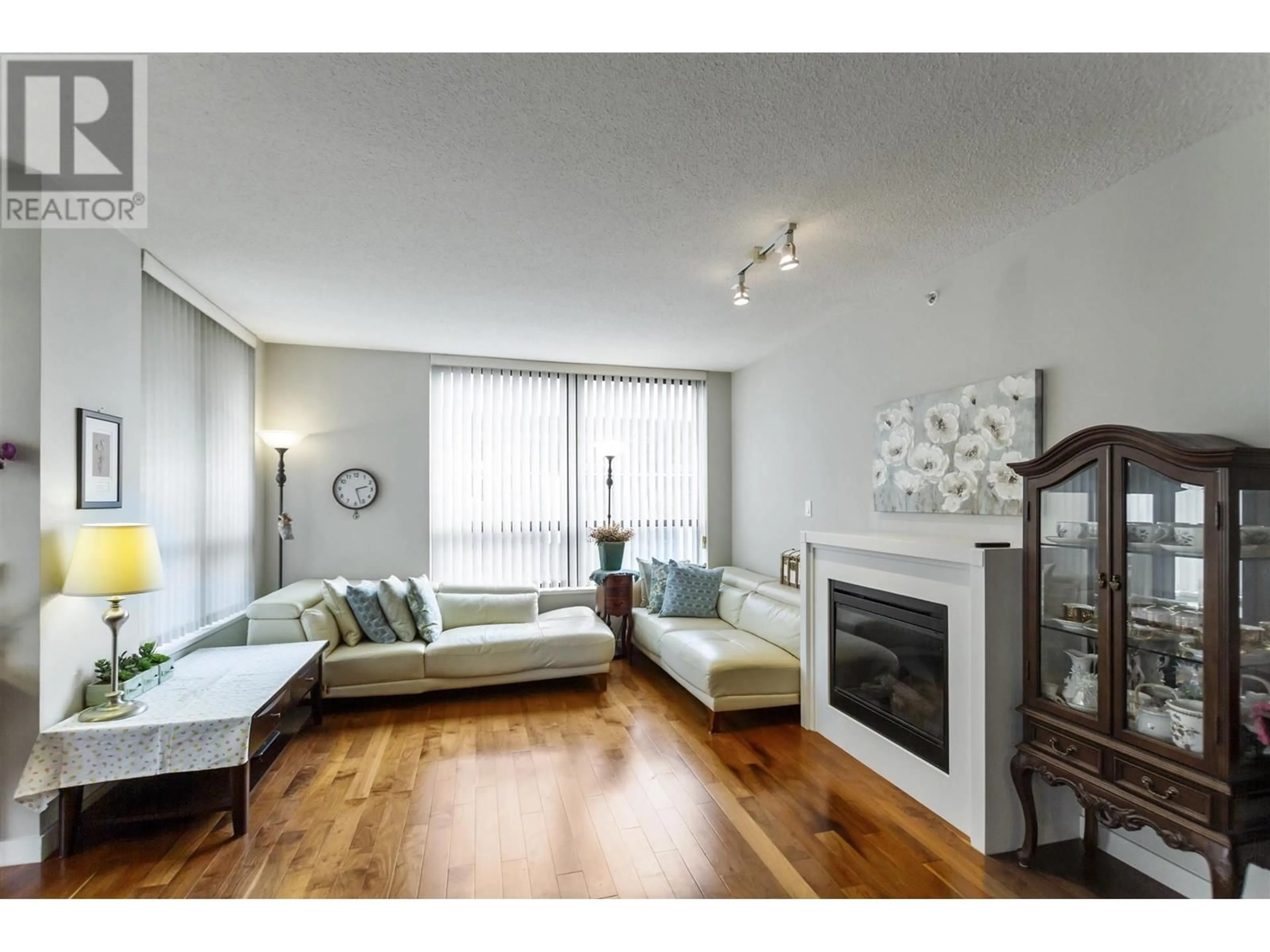 Living room with furniture, wood/laminate floor for 2003 2979 GLEN DRIVE, Coquitlam British Columbia V3B0B2