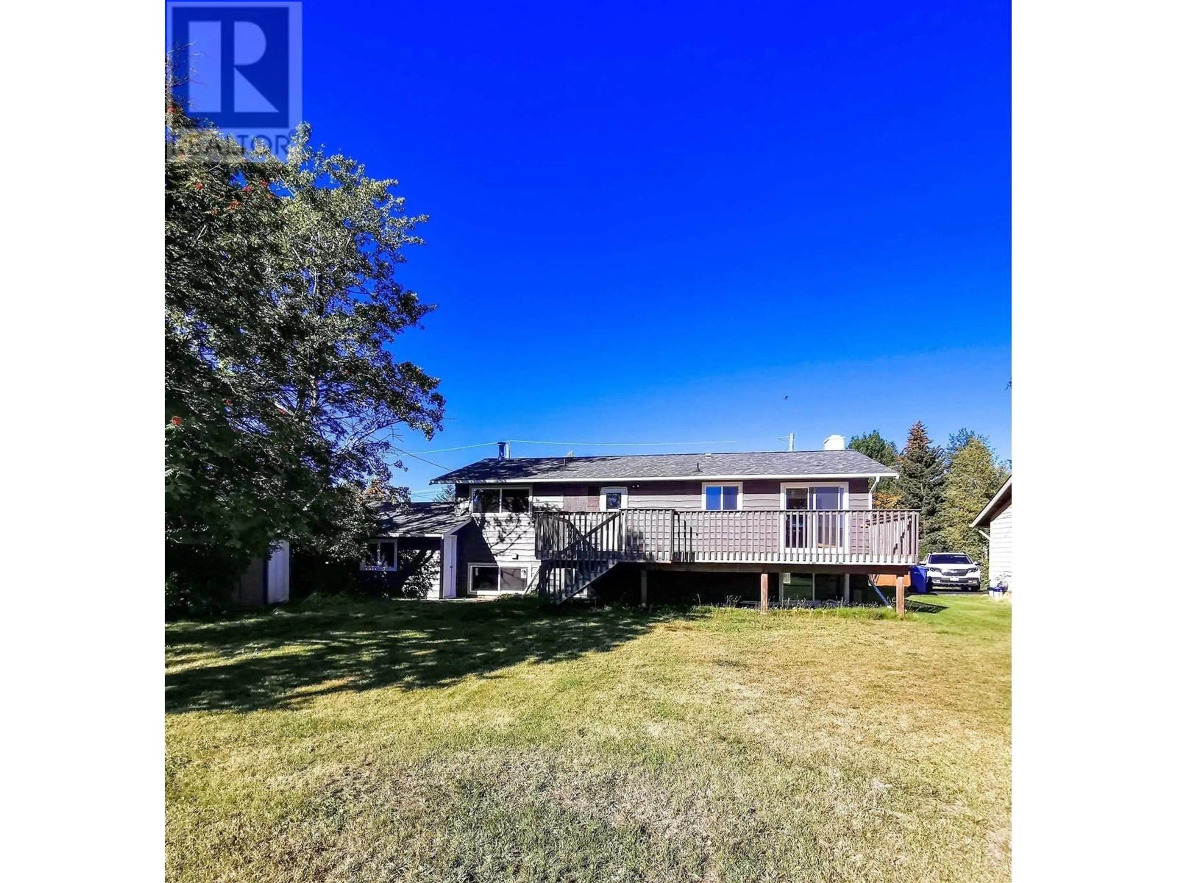 A pic from outside/outdoor area/front of a property/back of a property/a pic from drone, water/lake/river/ocean view for 205 EVERGREEN CRESCENT, 100 Mile House British Columbia V0K2E0