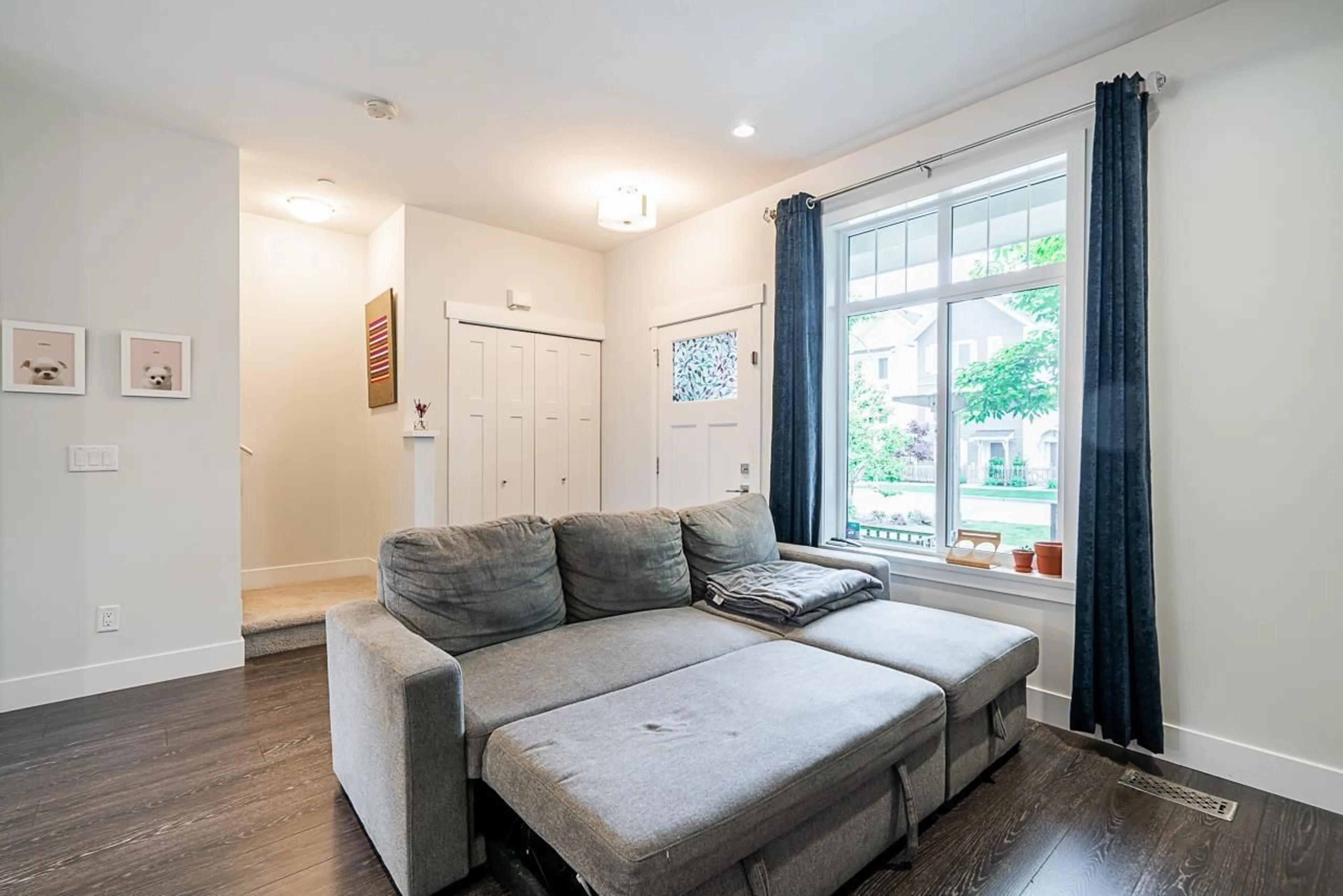 Living room with furniture, wood/laminate floor for 20416 84 AVENUE, Langley British Columbia V2Y0R6