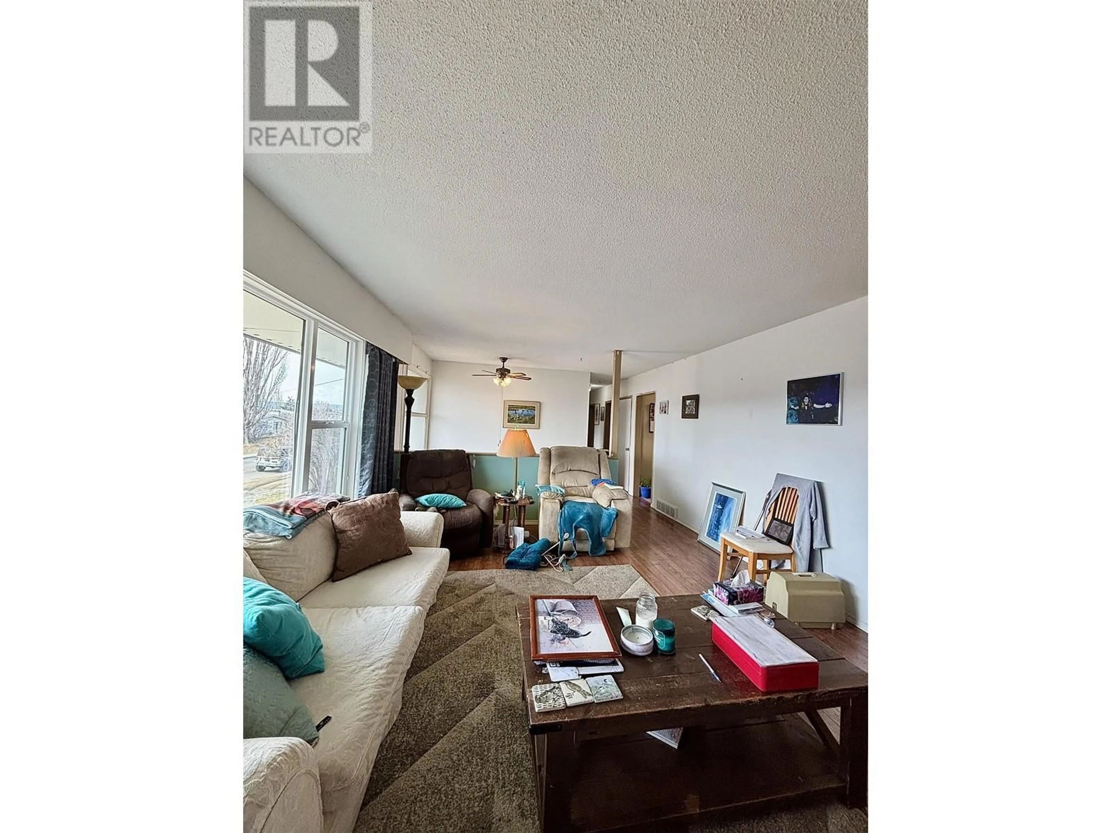 Living room with furniture, wood/laminate floor for 766 TENTH AVENUE, Williams Lake British Columbia V2G2L8