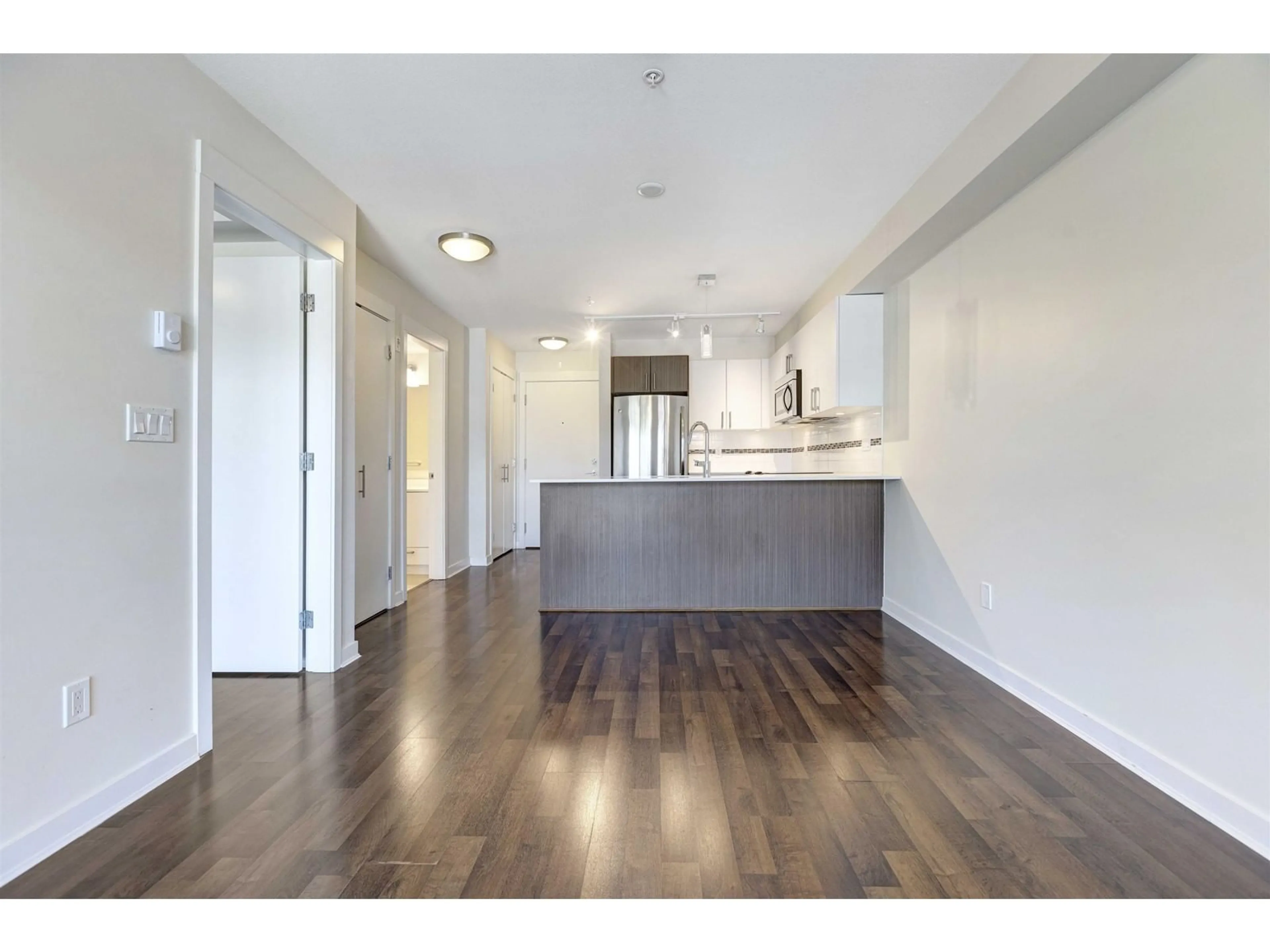 Open concept kitchen, wood/laminate floor for 202 8733 160 STREET, Surrey British Columbia V4N1G4