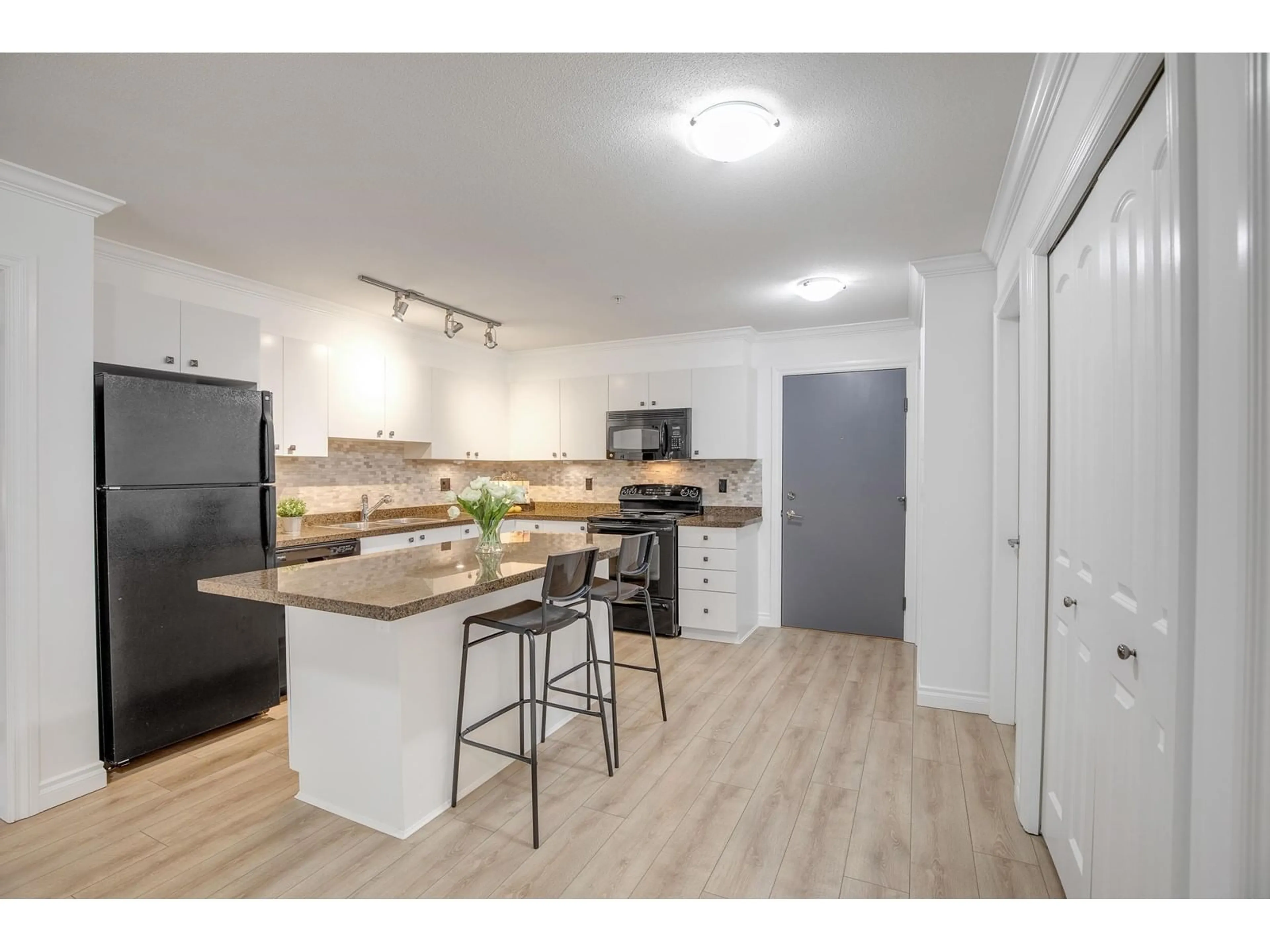 Open concept kitchen, wood/laminate floor for 205 8717 160 STREET, Surrey British Columbia V4N5X7