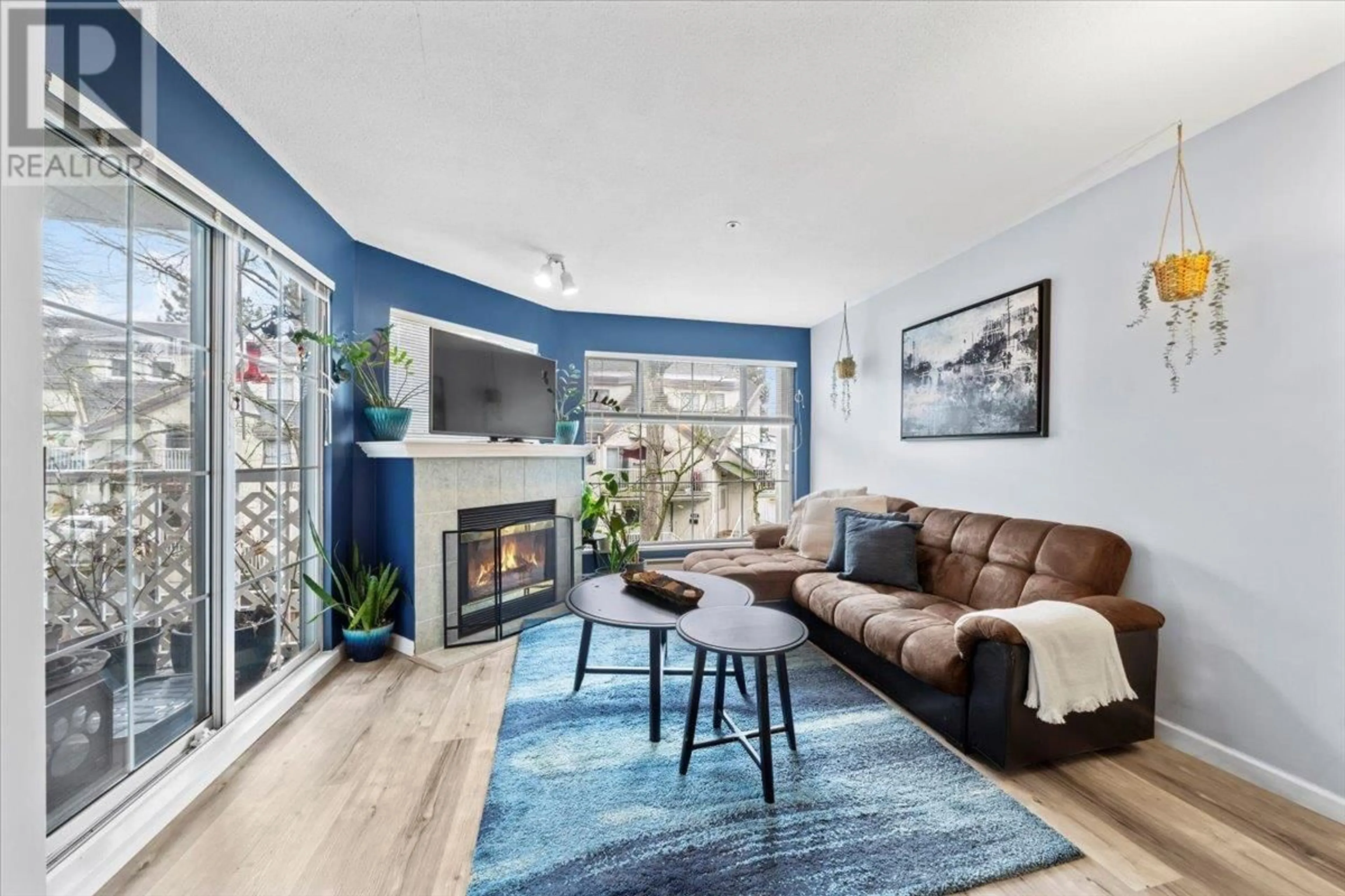 Living room with furniture, wood/laminate floor for 215 - 2678 DIXON STREET, Port Coquitlam British Columbia V3C6L7