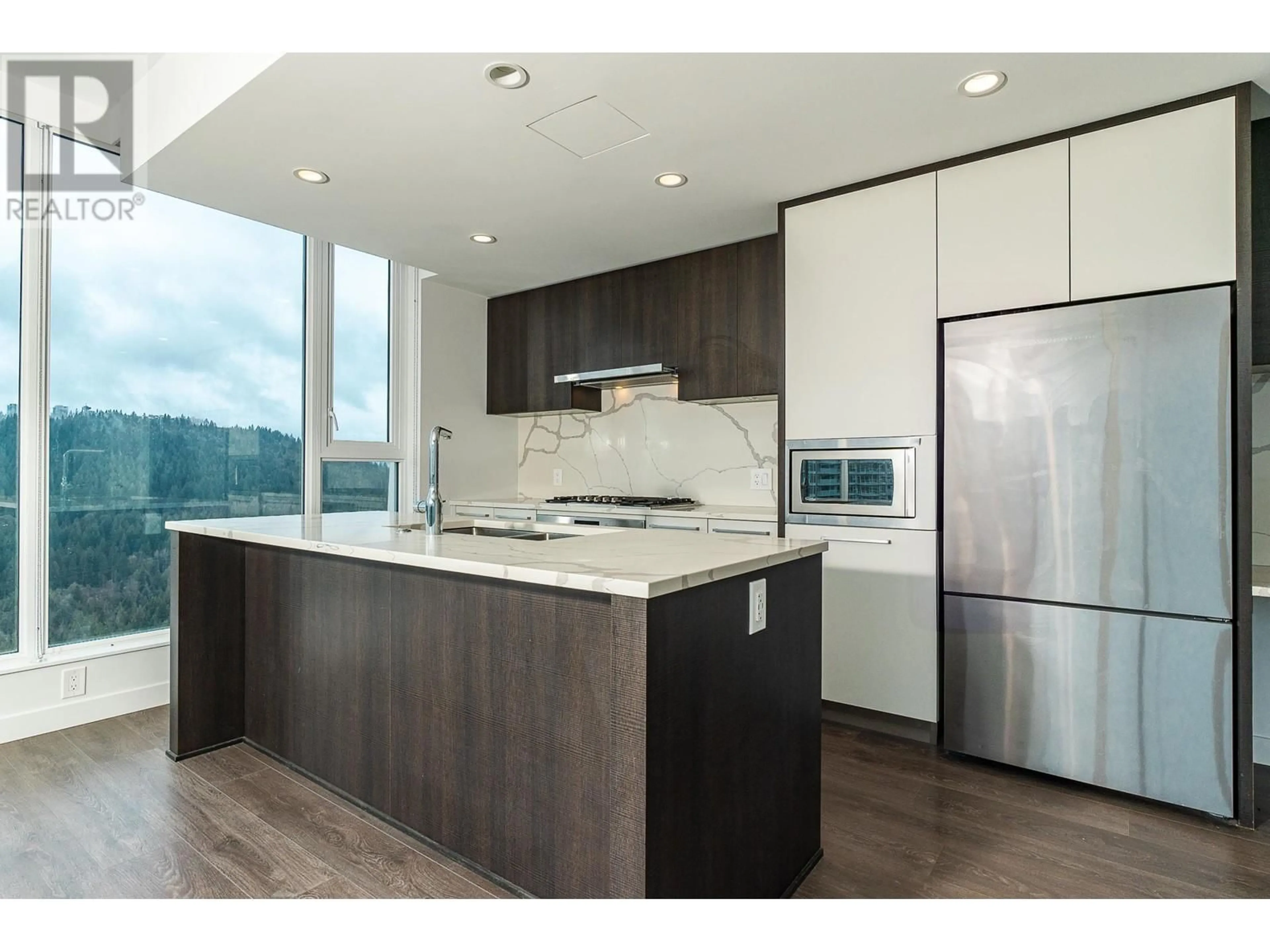 Open concept kitchen, wood/laminate floor for 3901 - 567 CLARKE ROAD, Coquitlam British Columbia V3J0K7