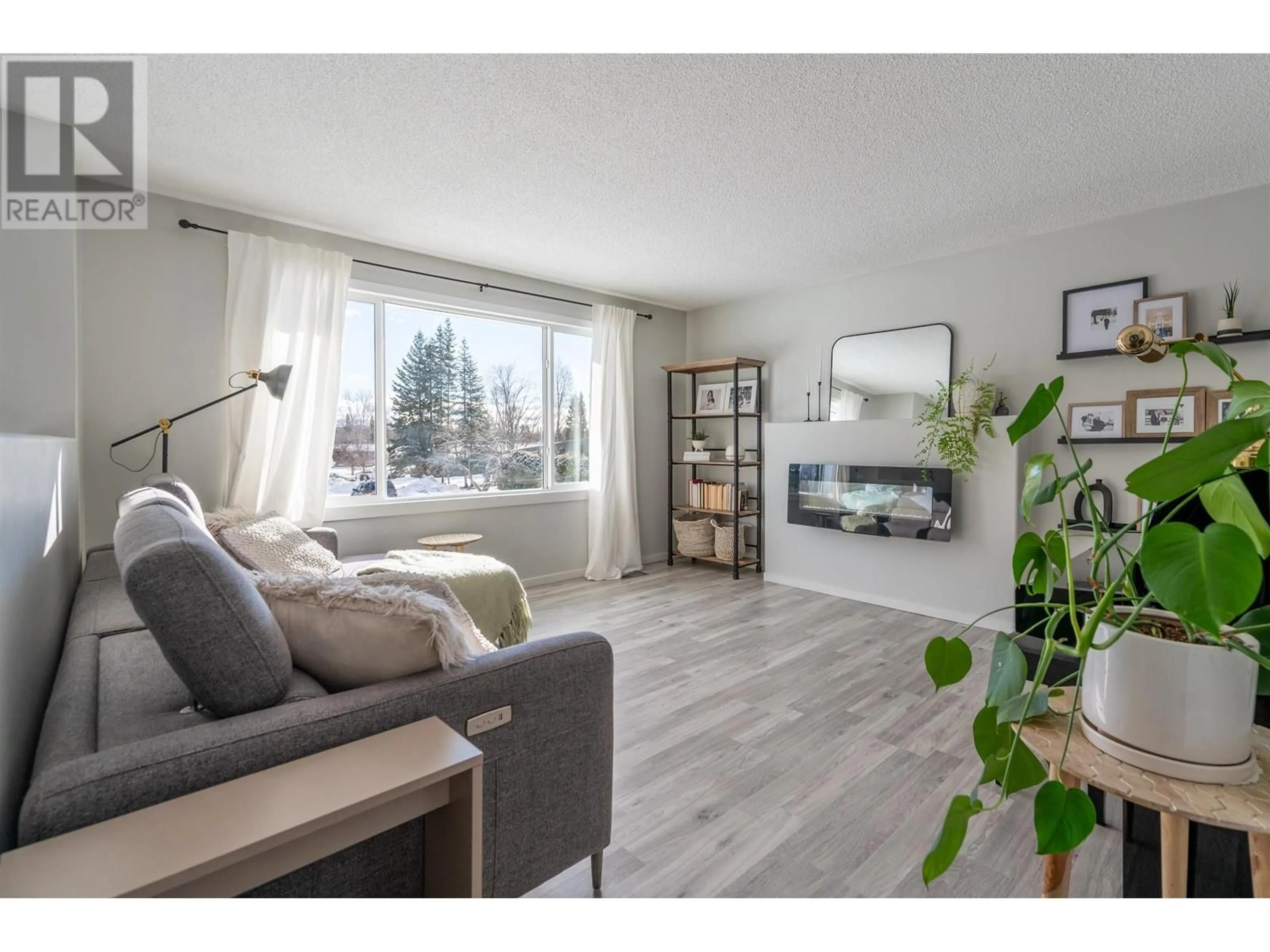 Living room with furniture, wood/laminate floor for 6137 CALEDONIA CRESCENT, Prince George British Columbia V2N2H5