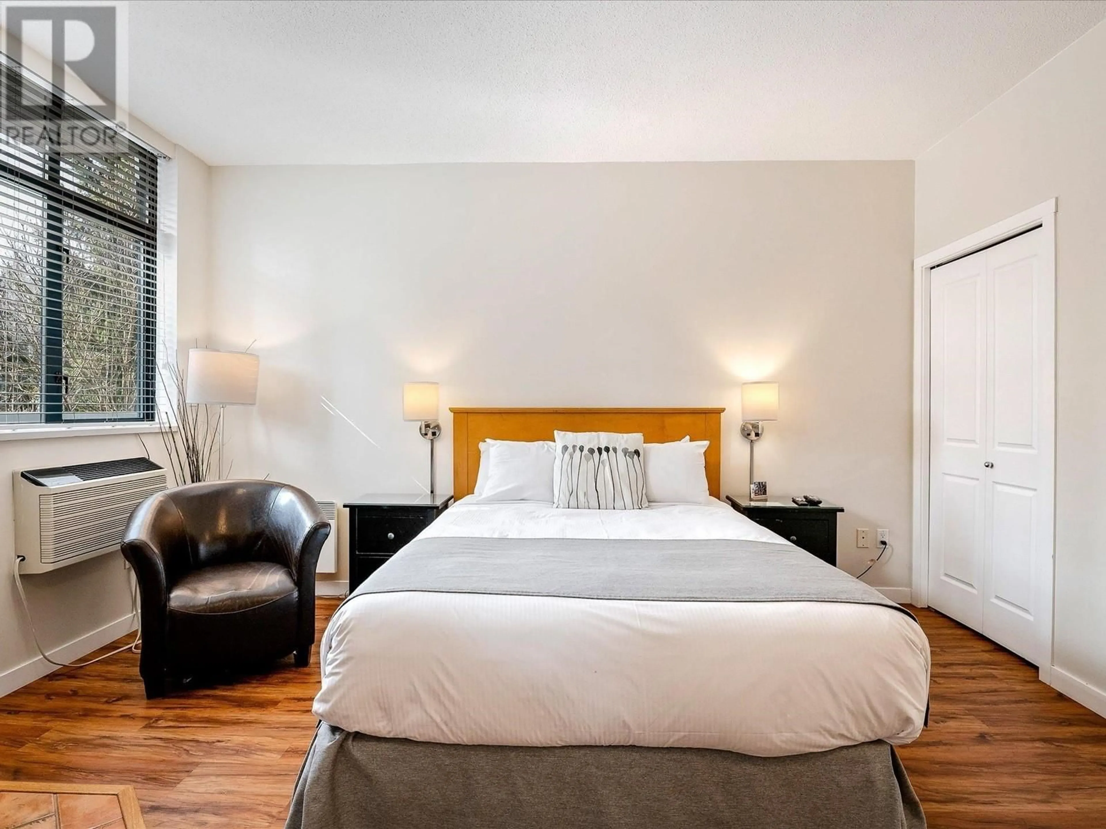 Bedroom with bed, wood/laminate floor for 210 - 4369 MAIN STREET, Whistler British Columbia V8E1B7