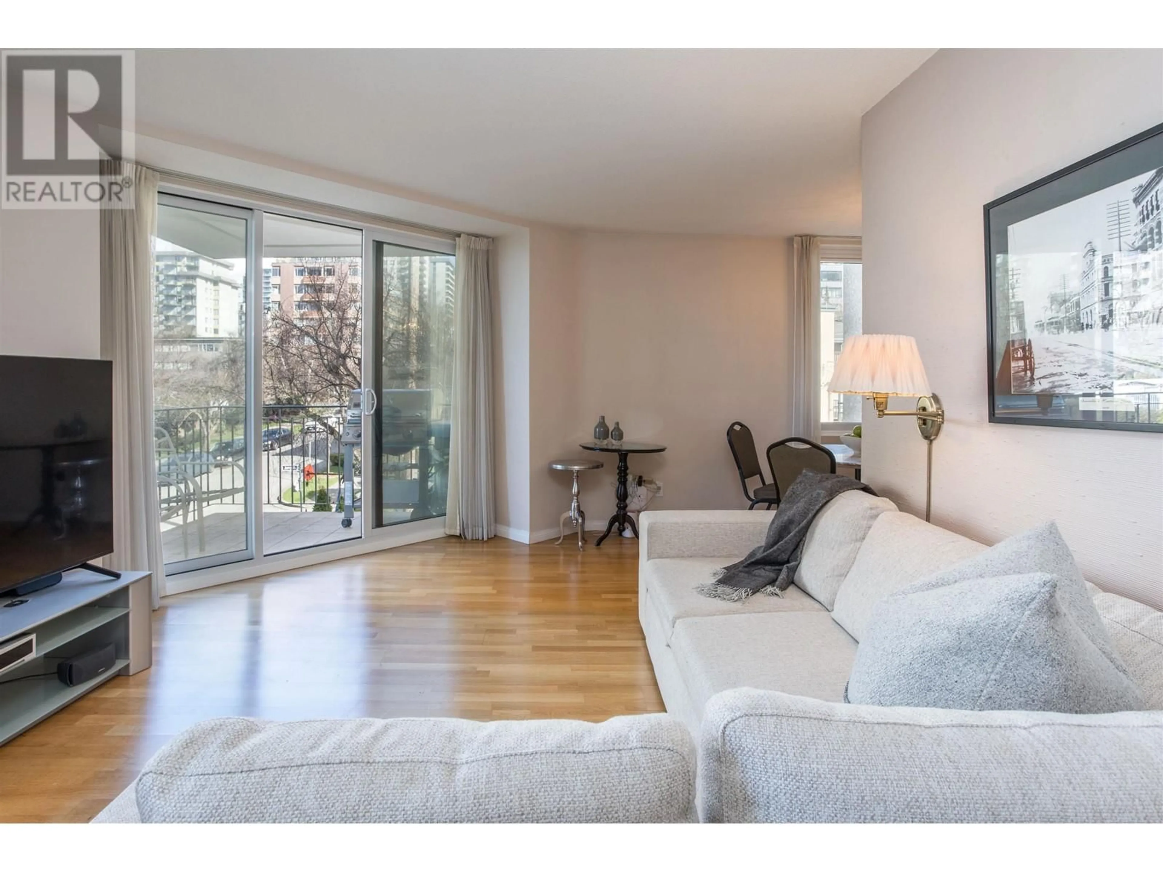 Living room with furniture, wood/laminate floor for 303 1575 BEACH AVENUE, Vancouver British Columbia V6G1Y5