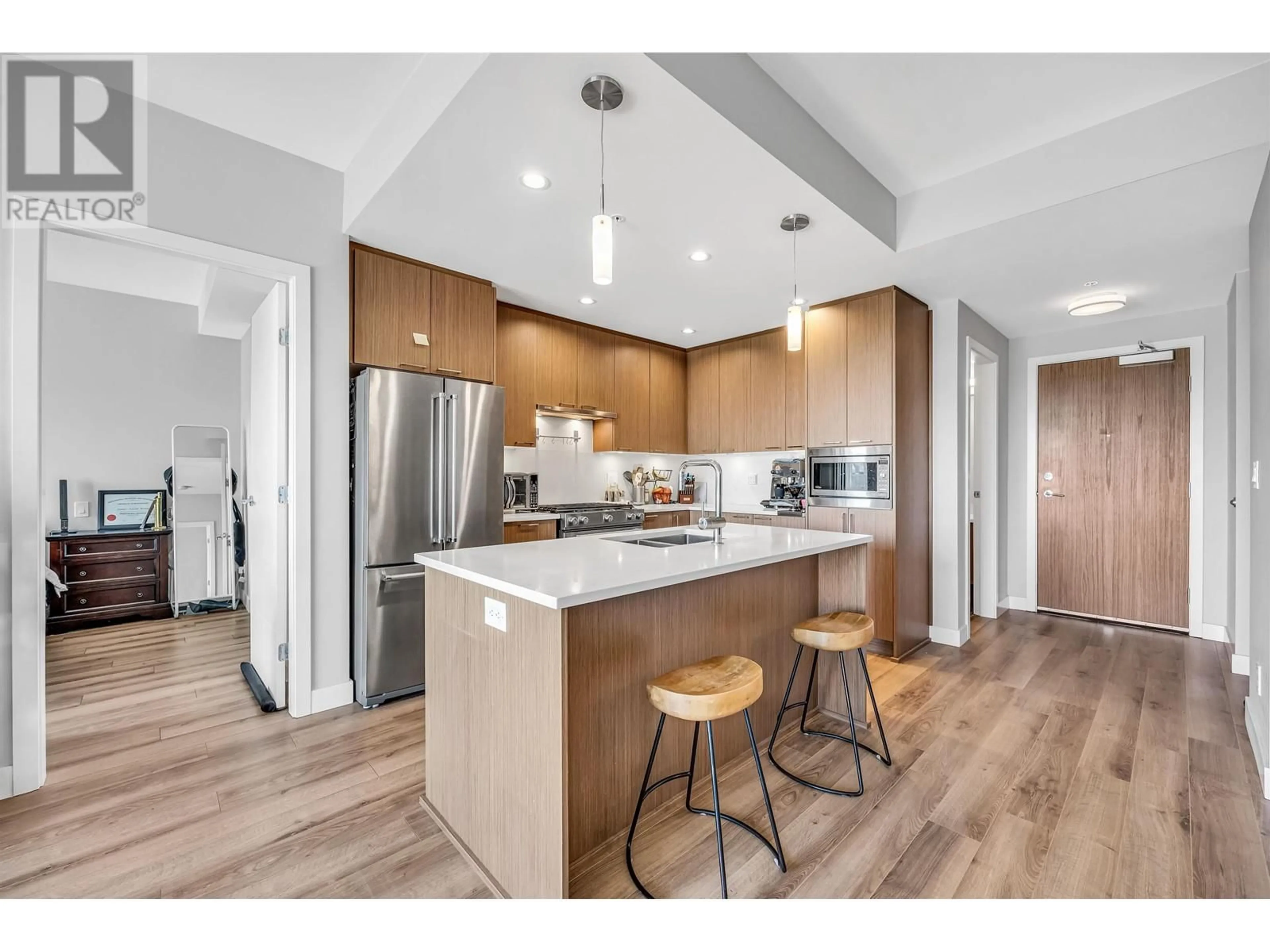 Open concept kitchen, wood/laminate floor for 406 - 4289 HASTINGS STREET, Burnaby British Columbia V5C2J5