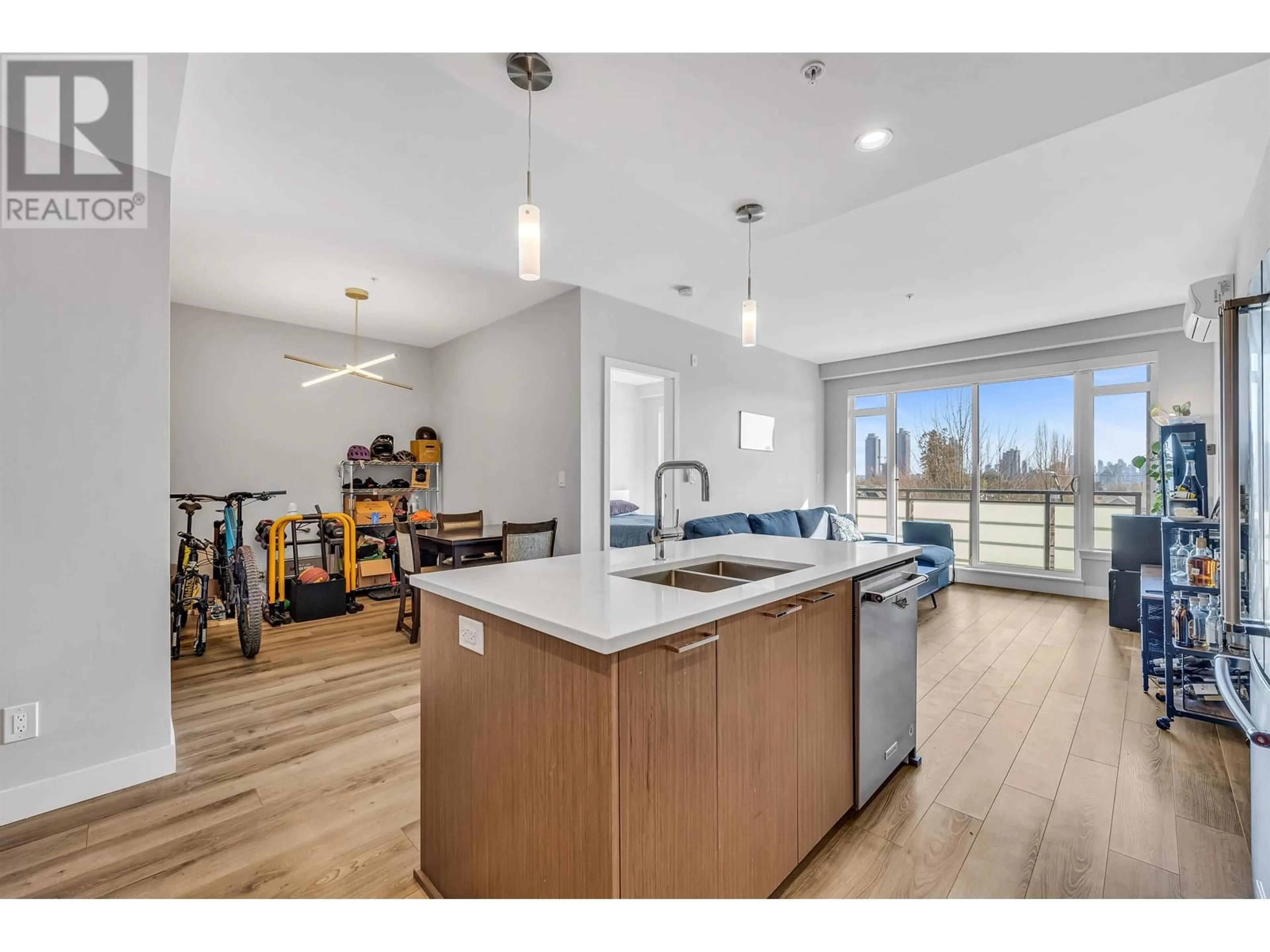 Open concept kitchen, wood/laminate floor for 406 - 4289 HASTINGS STREET, Burnaby British Columbia V5C2J5
