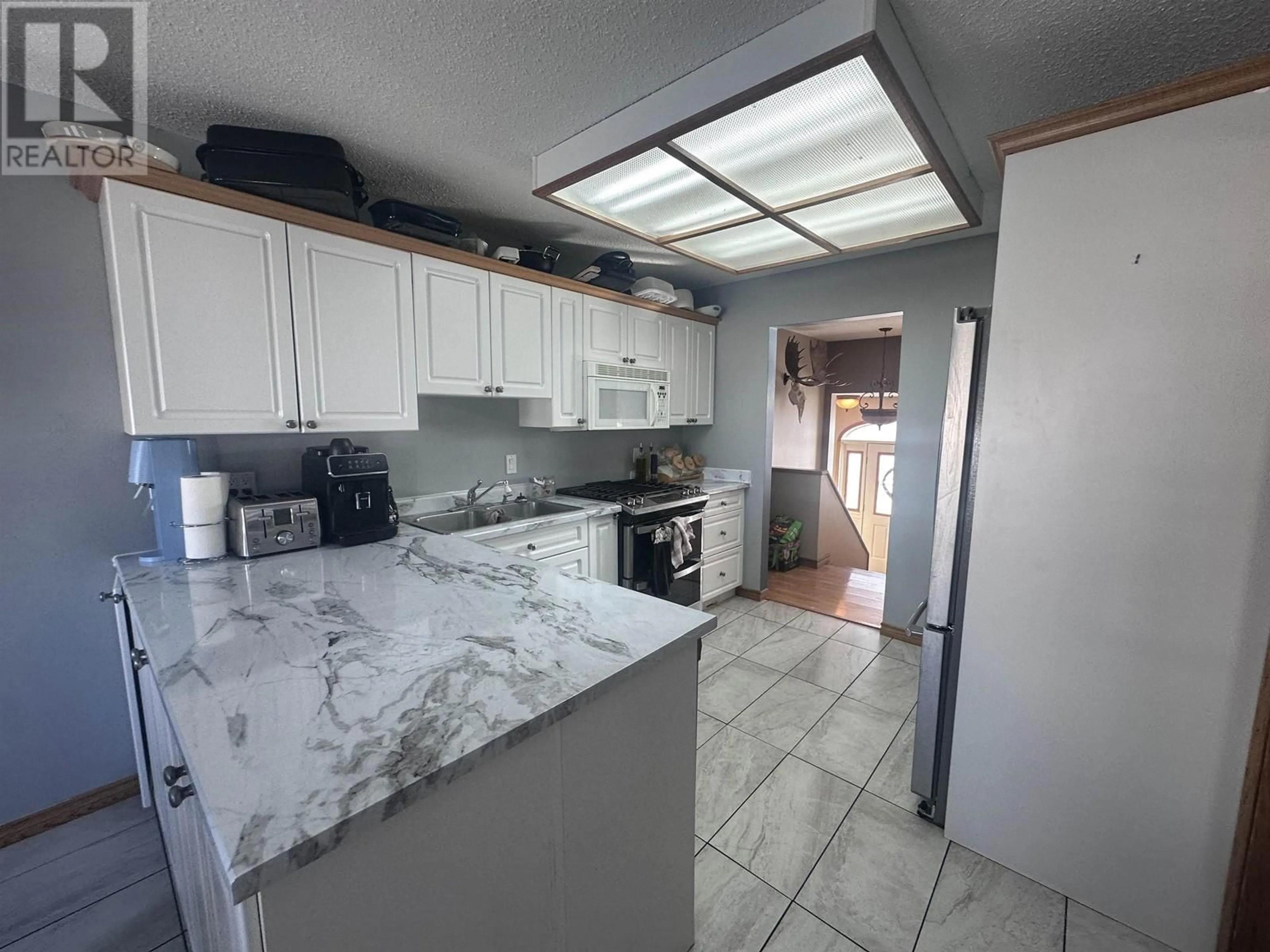 Open concept kitchen, ceramic/tile floor for 5551 MAXHAMISH CRESCENT, Fort Nelson British Columbia V0C1R0