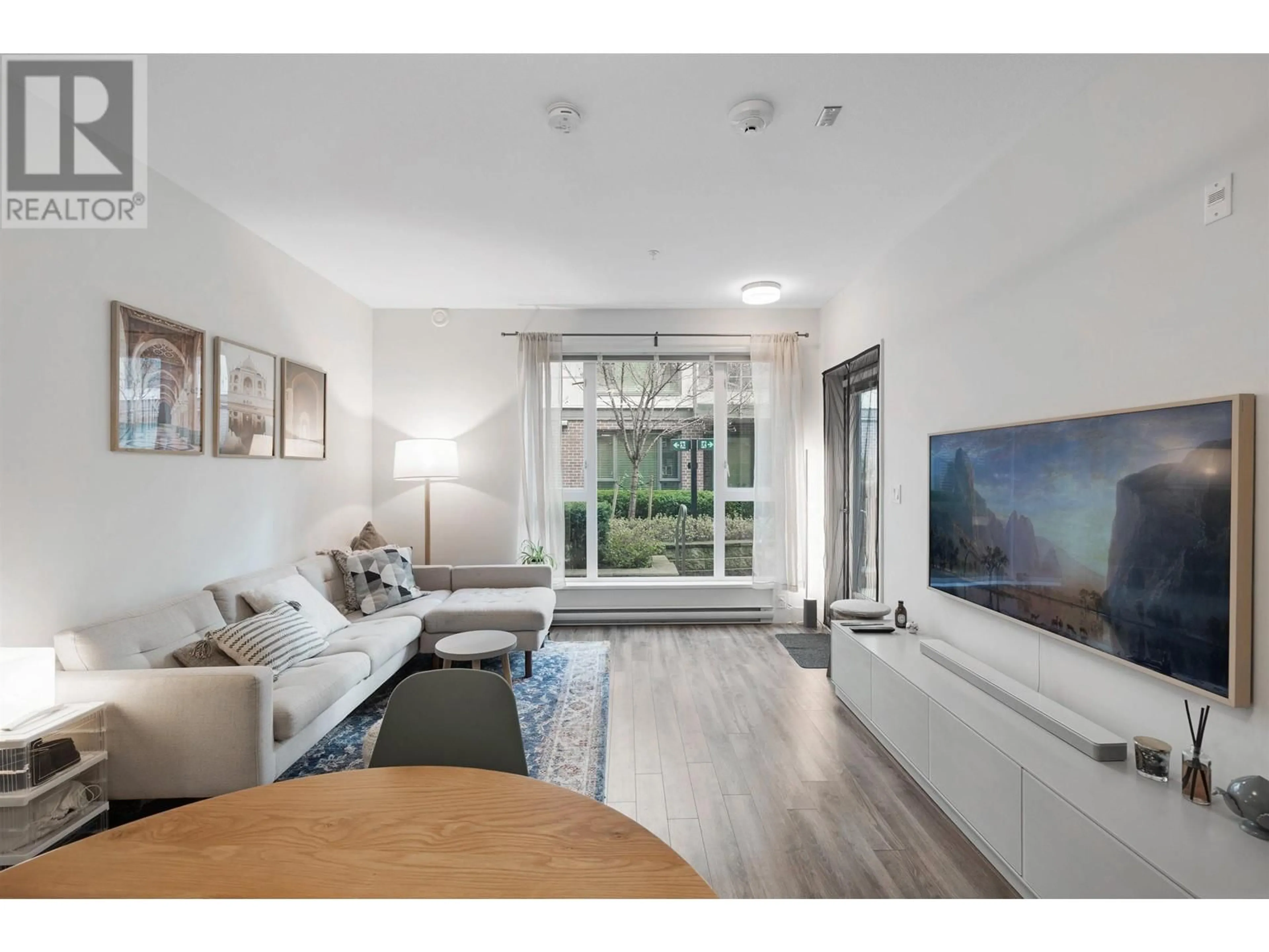Living room with furniture, wood/laminate floor for 102 - 5355 LANE STREET, Burnaby British Columbia V5H0H1