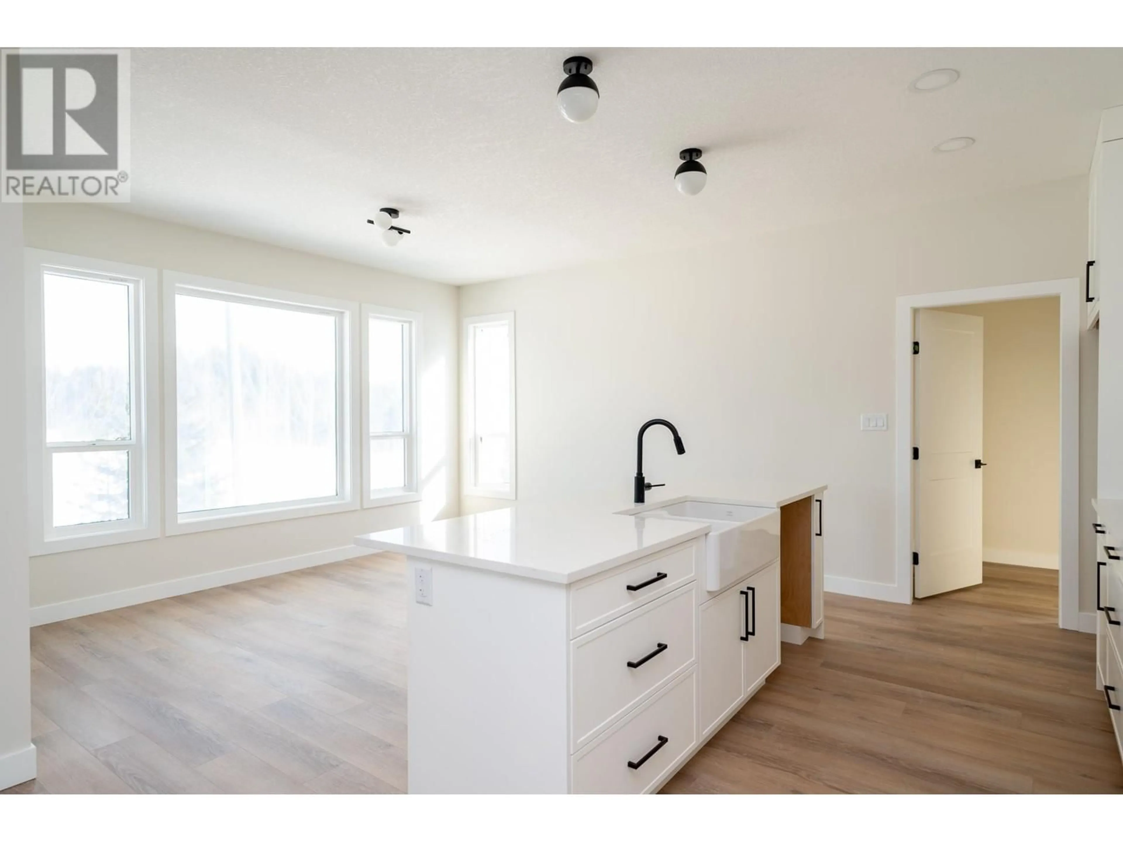 Open concept kitchen, wood/laminate floor for 2464 MCTAVISH ROAD, Prince George British Columbia V2K0A1