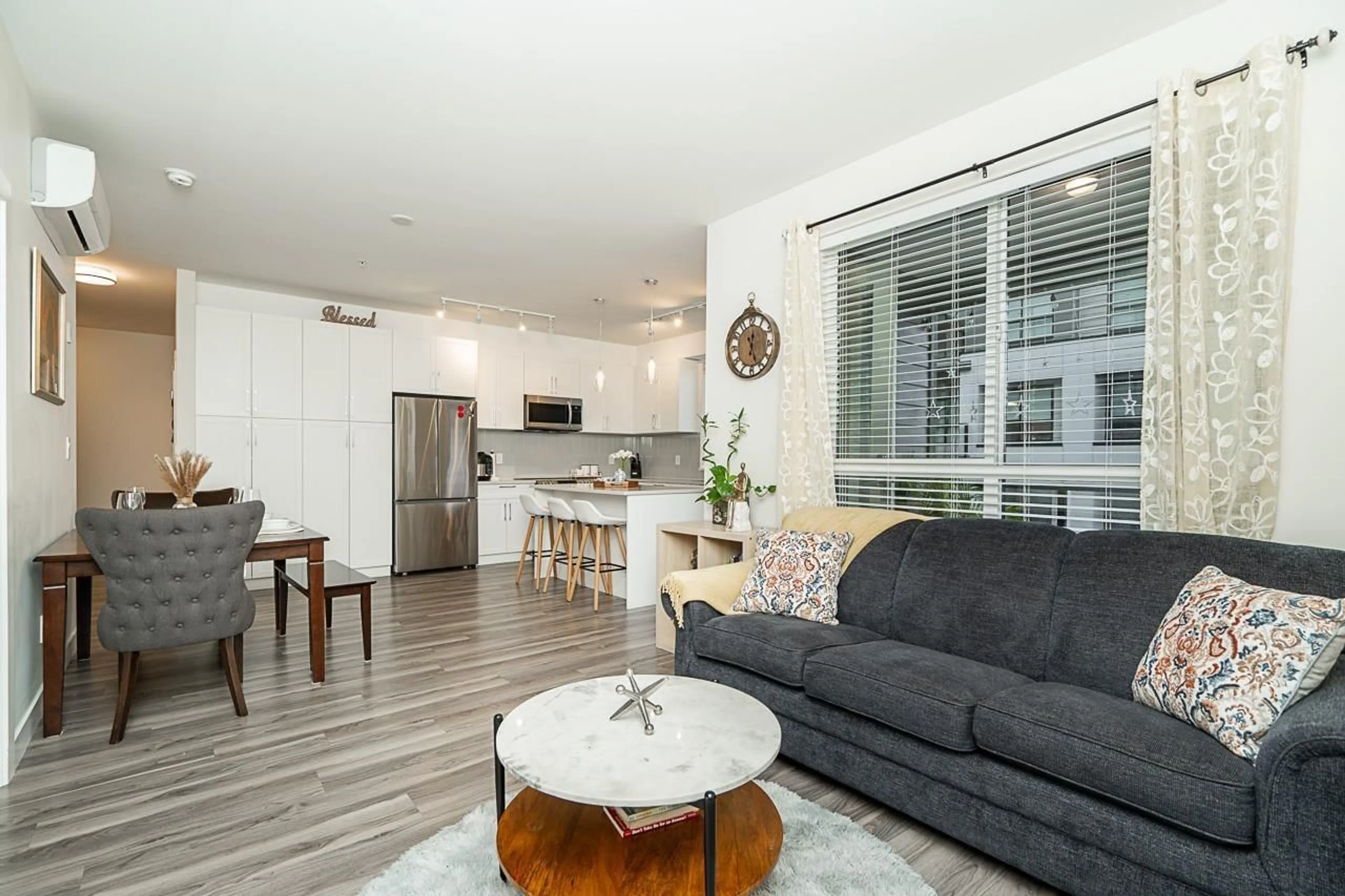Living room with furniture, wood/laminate floor for 210 - 20356 72B, Langley British Columbia V2Y4J9