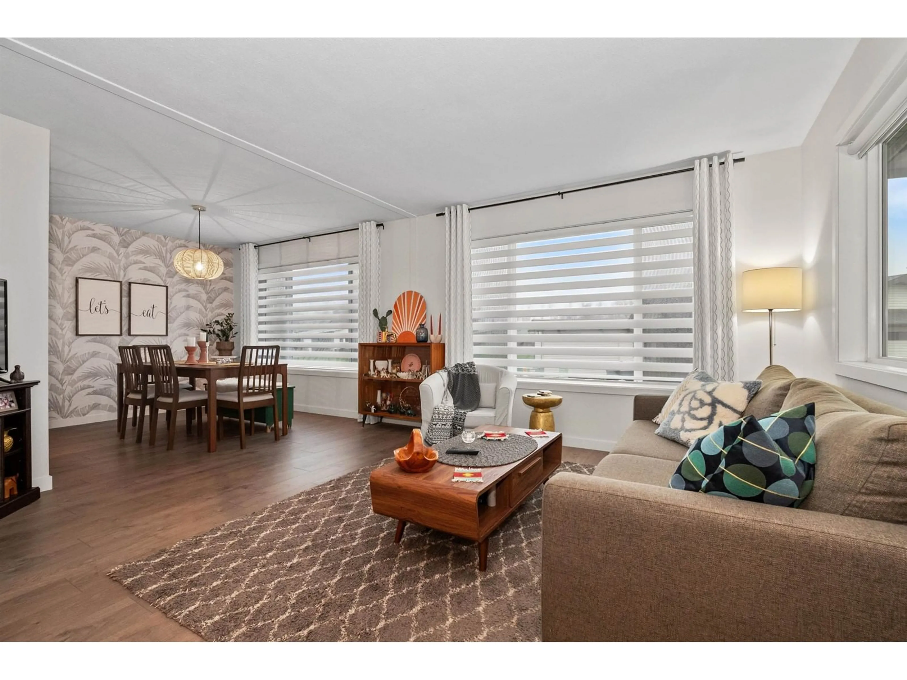 Living room with furniture, wood/laminate floor for 101 - 9055 ASHWELL ROAD, Chilliwack British Columbia V2P7S6