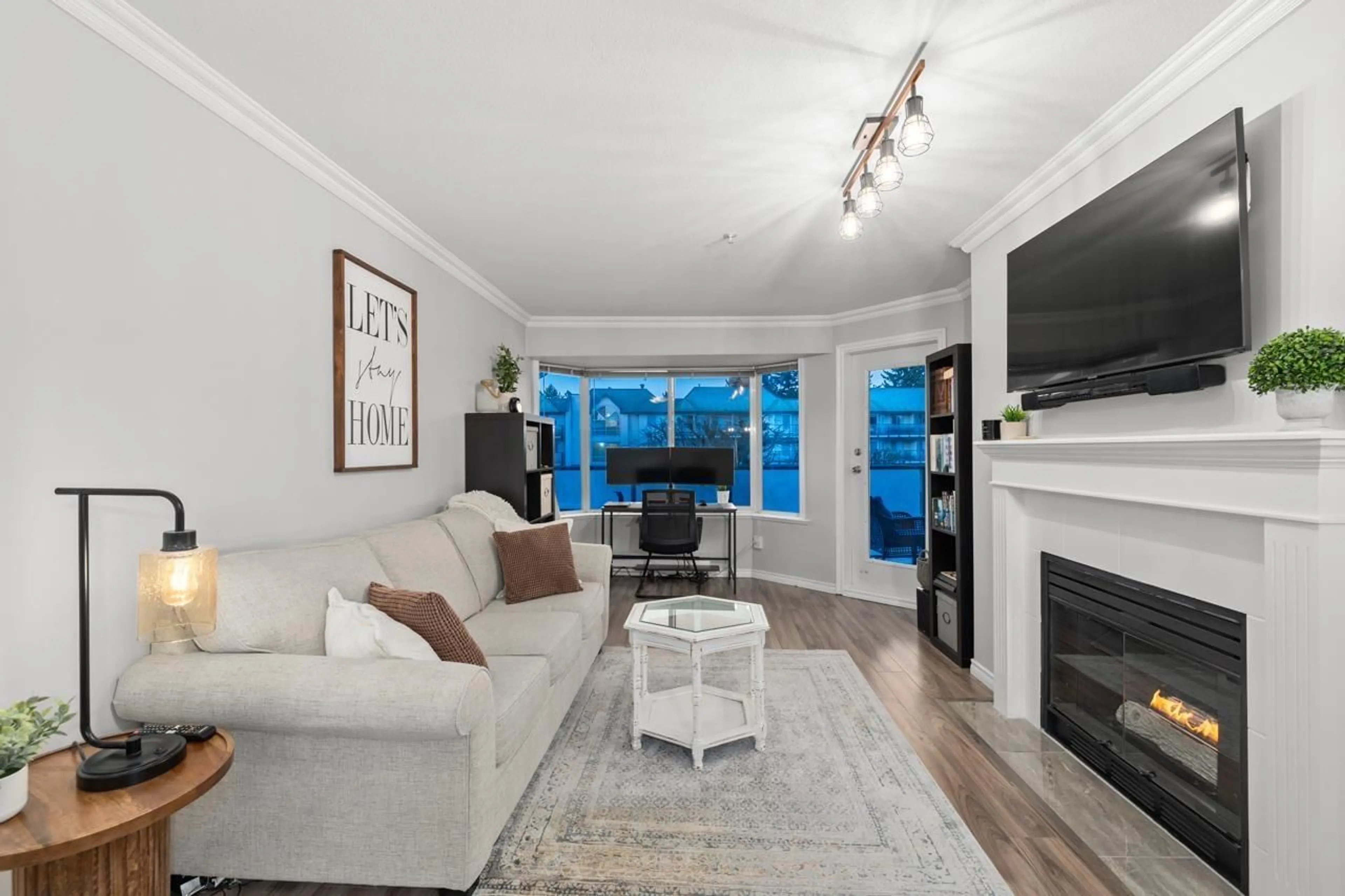 Living room with furniture, wood/laminate floor for 310 - 2958 TRETHEWEY, Abbotsford British Columbia V2T6P6