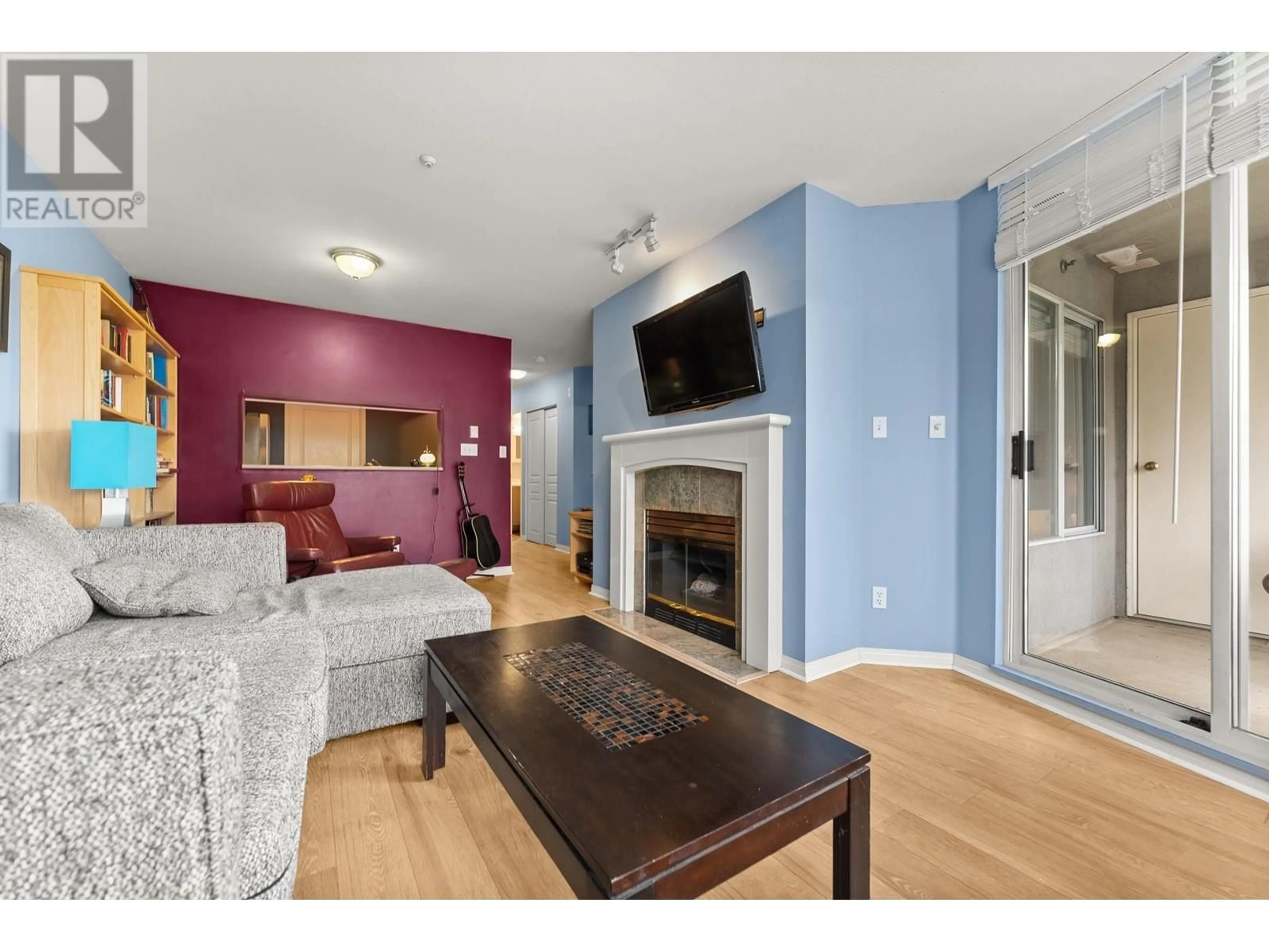 Living room with furniture, wood/laminate floor for 103 - 8420 JELLICOE STREET, Vancouver British Columbia V5S4T1