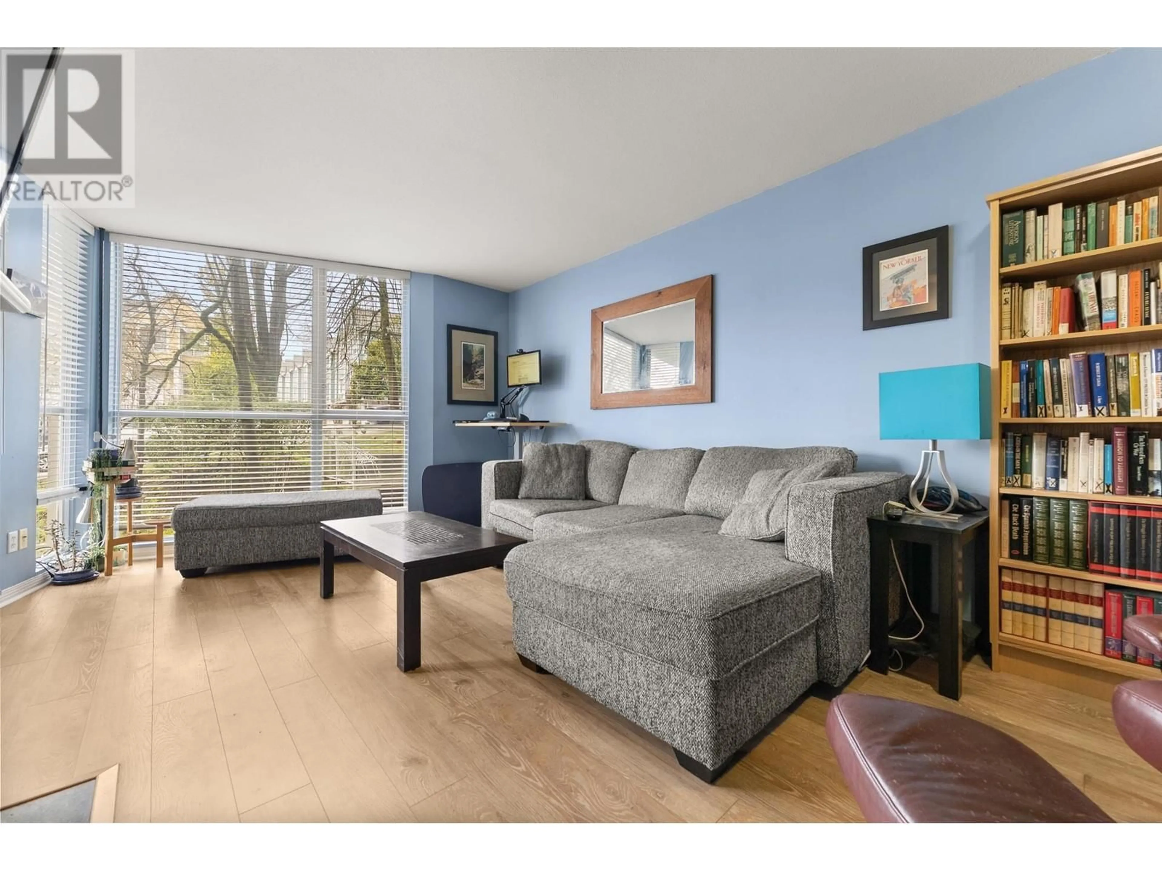 Living room with furniture, wood/laminate floor for 103 - 8420 JELLICOE STREET, Vancouver British Columbia V5S4T1