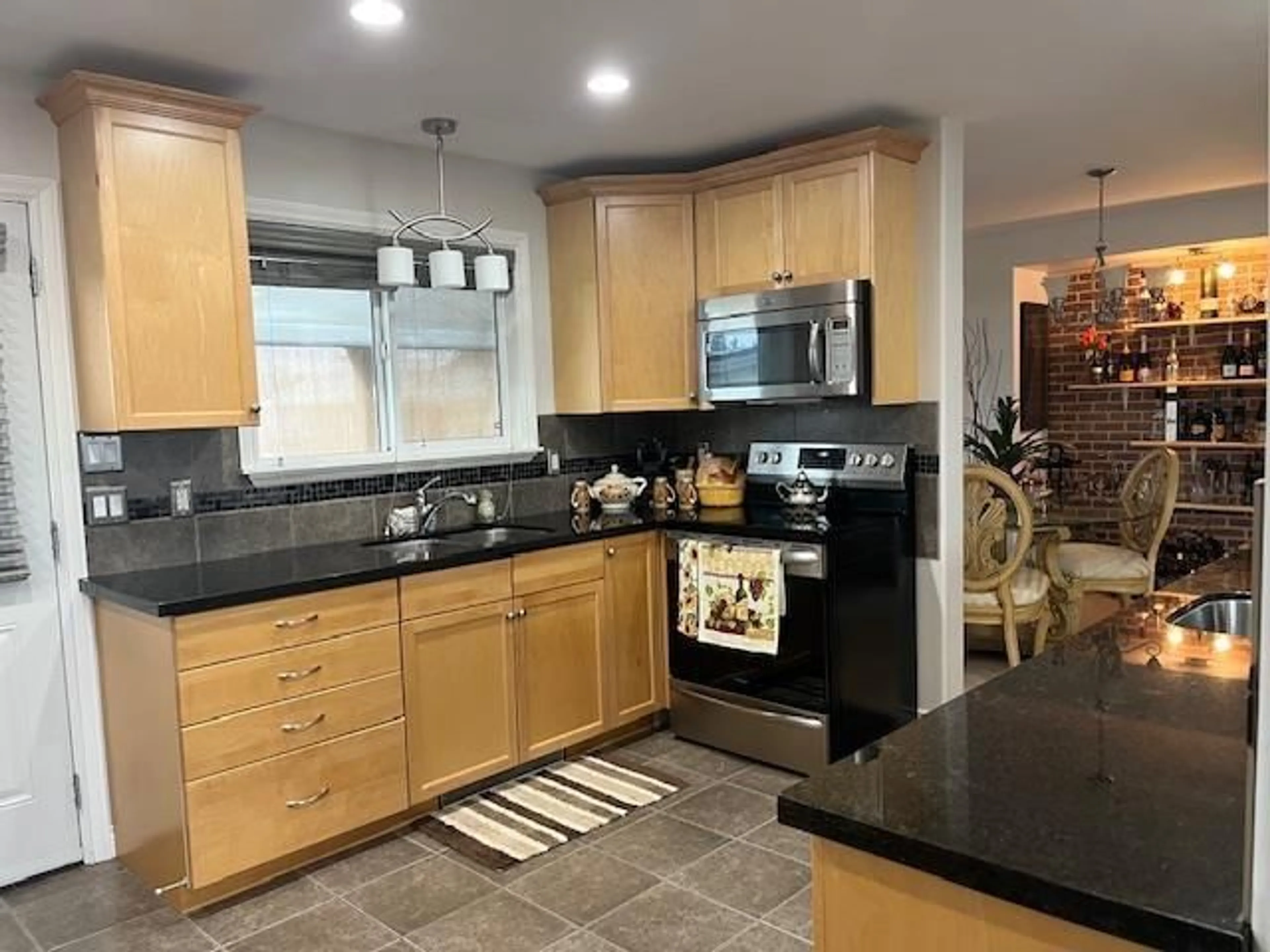 Open concept kitchen, ceramic/tile floor for 7055 SESAME STREET, Chilliwack British Columbia V2R3T3