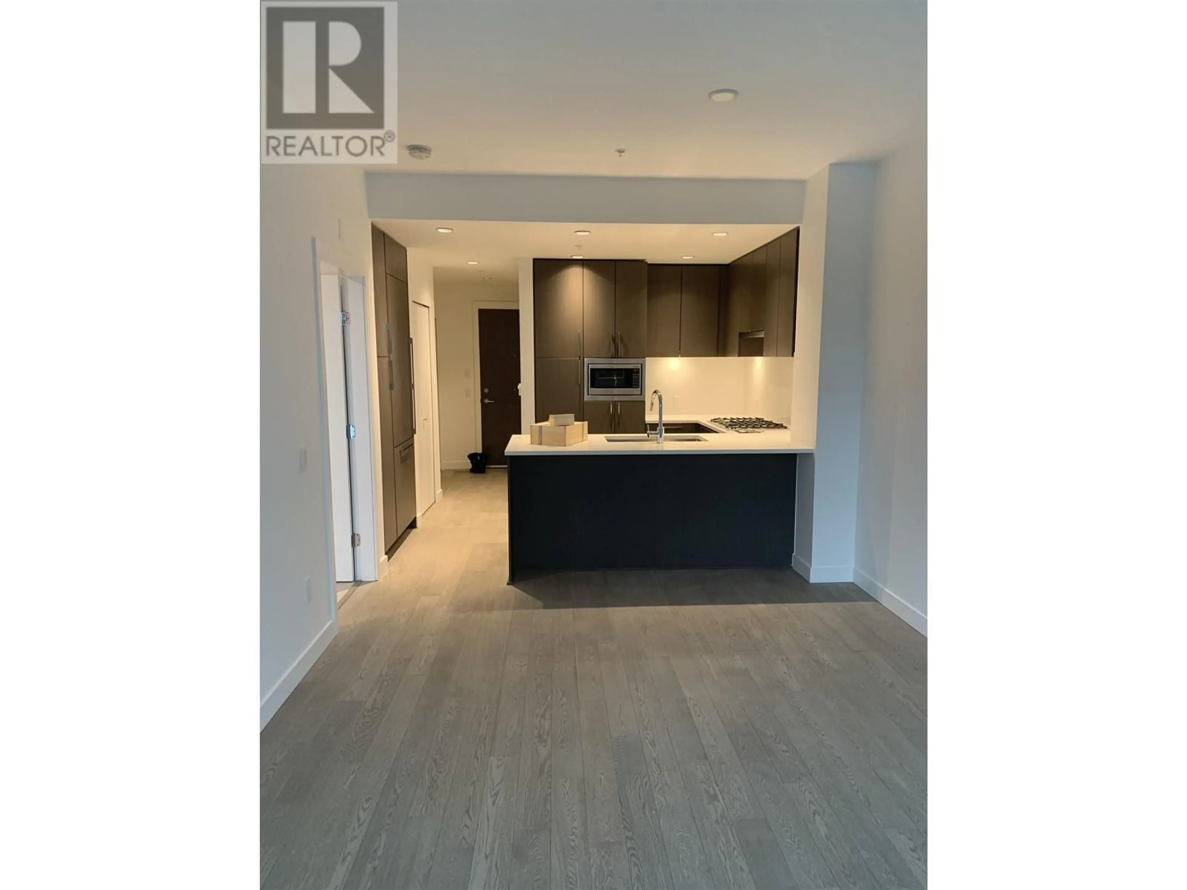 Open concept kitchen, wood/laminate floor for 407 - 489 26TH, Vancouver British Columbia V5Y0M8