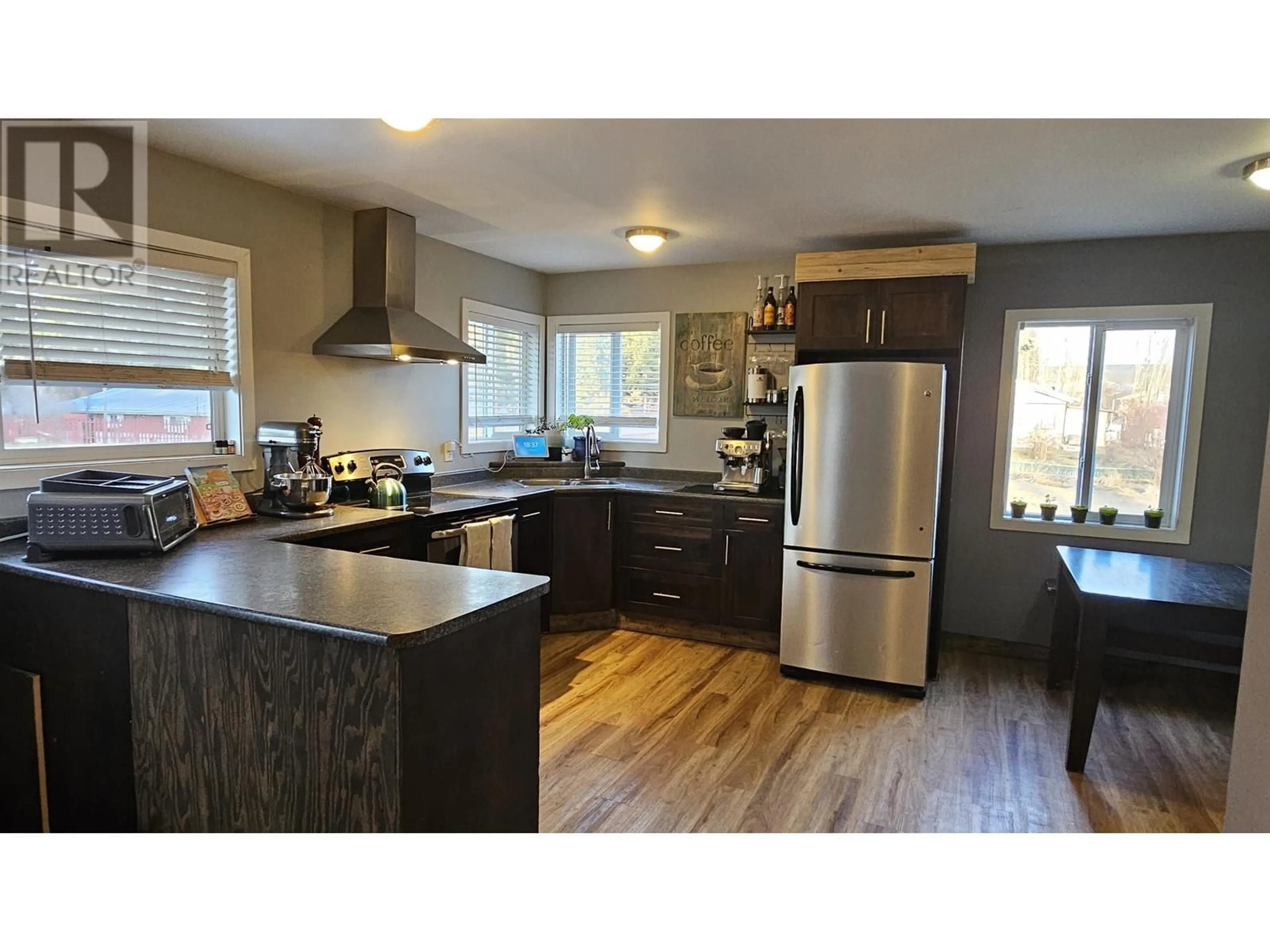 Open concept kitchen, wood/laminate floor for 1785 BIRCH AVENUE, Quesnel British Columbia V2J3Y3