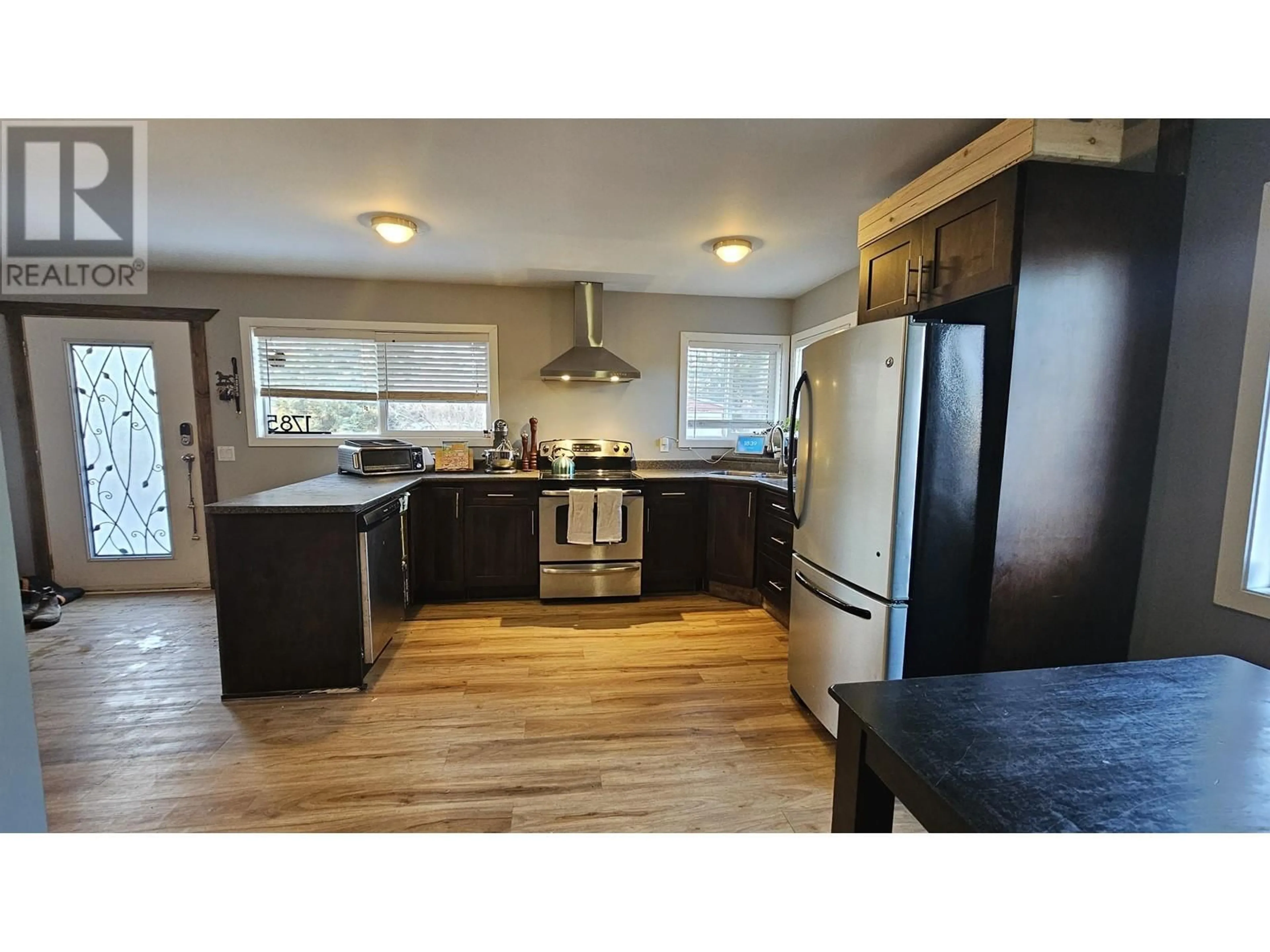 Open concept kitchen, wood/laminate floor for 1785 BIRCH AVENUE, Quesnel British Columbia V2J3Y3