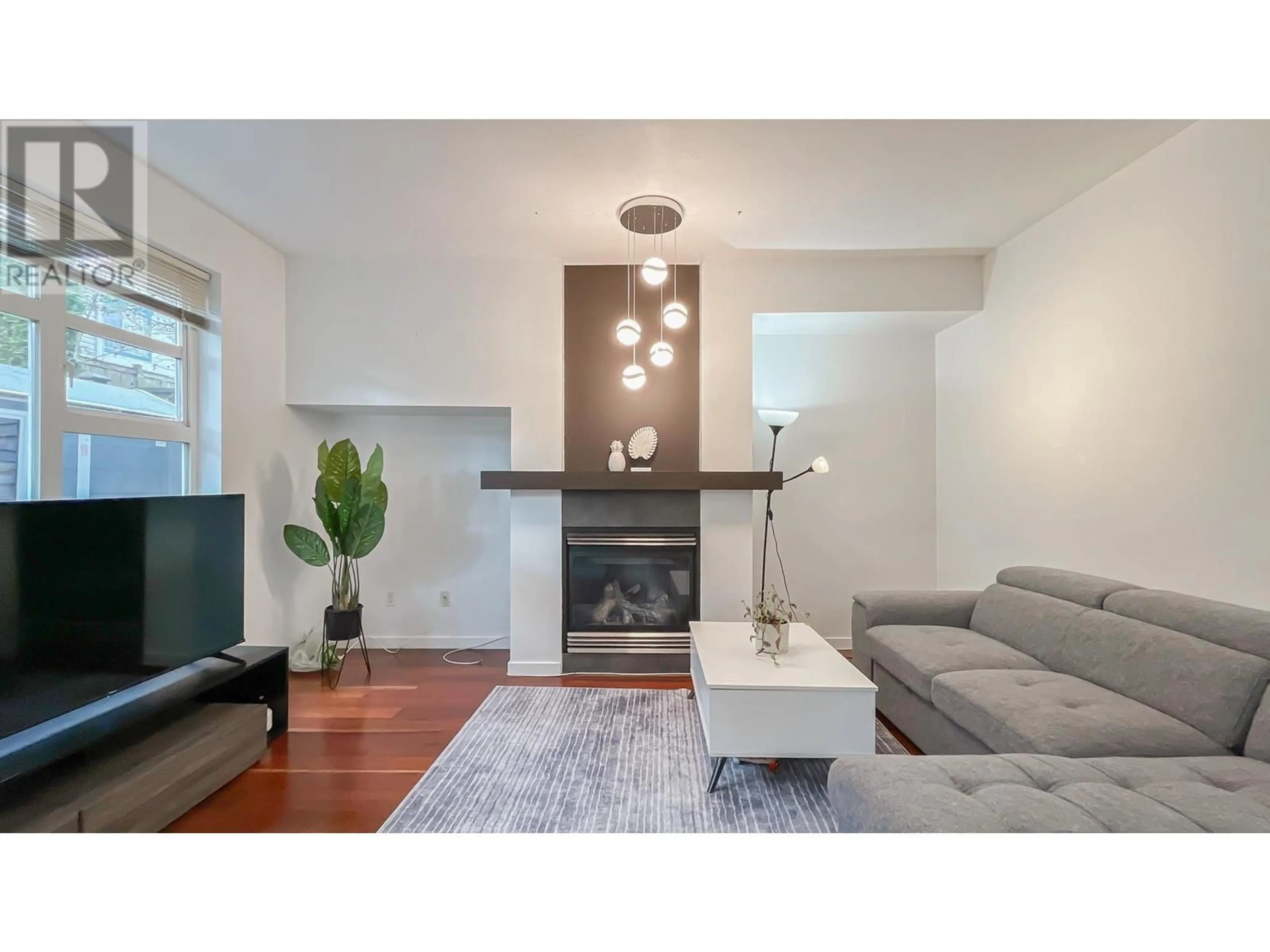 Living room with furniture, wood/laminate floor for 41 - 6528 DENBIGH AVENUE, Burnaby British Columbia V5H3R8