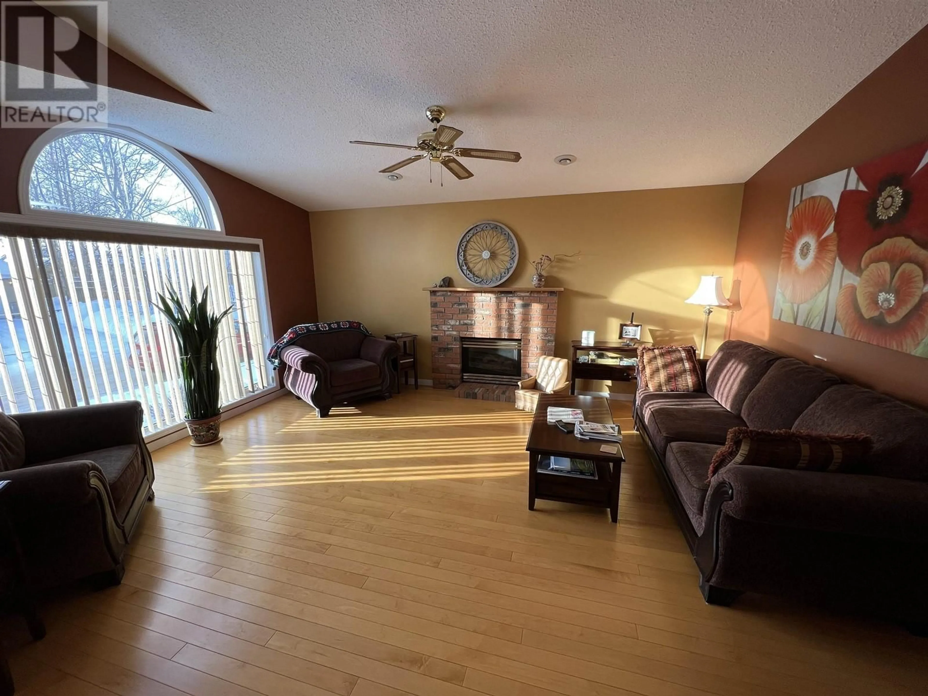 Living room with furniture, wood/laminate floor for 5504 CHURCHILL AVENUE, Fort Nelson British Columbia V0C1R0