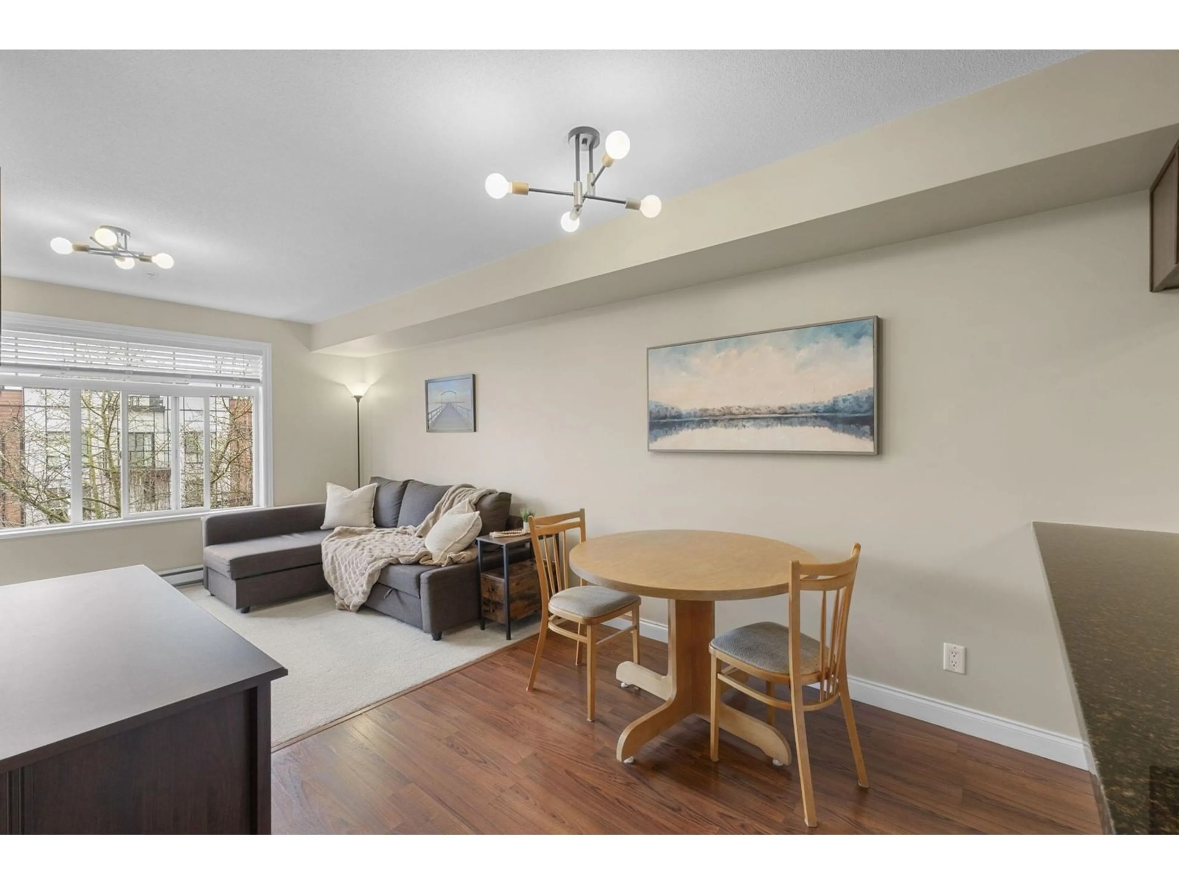 Living room with furniture, wood/laminate floor for 320 - 5516 198, Langley British Columbia V3A0A6