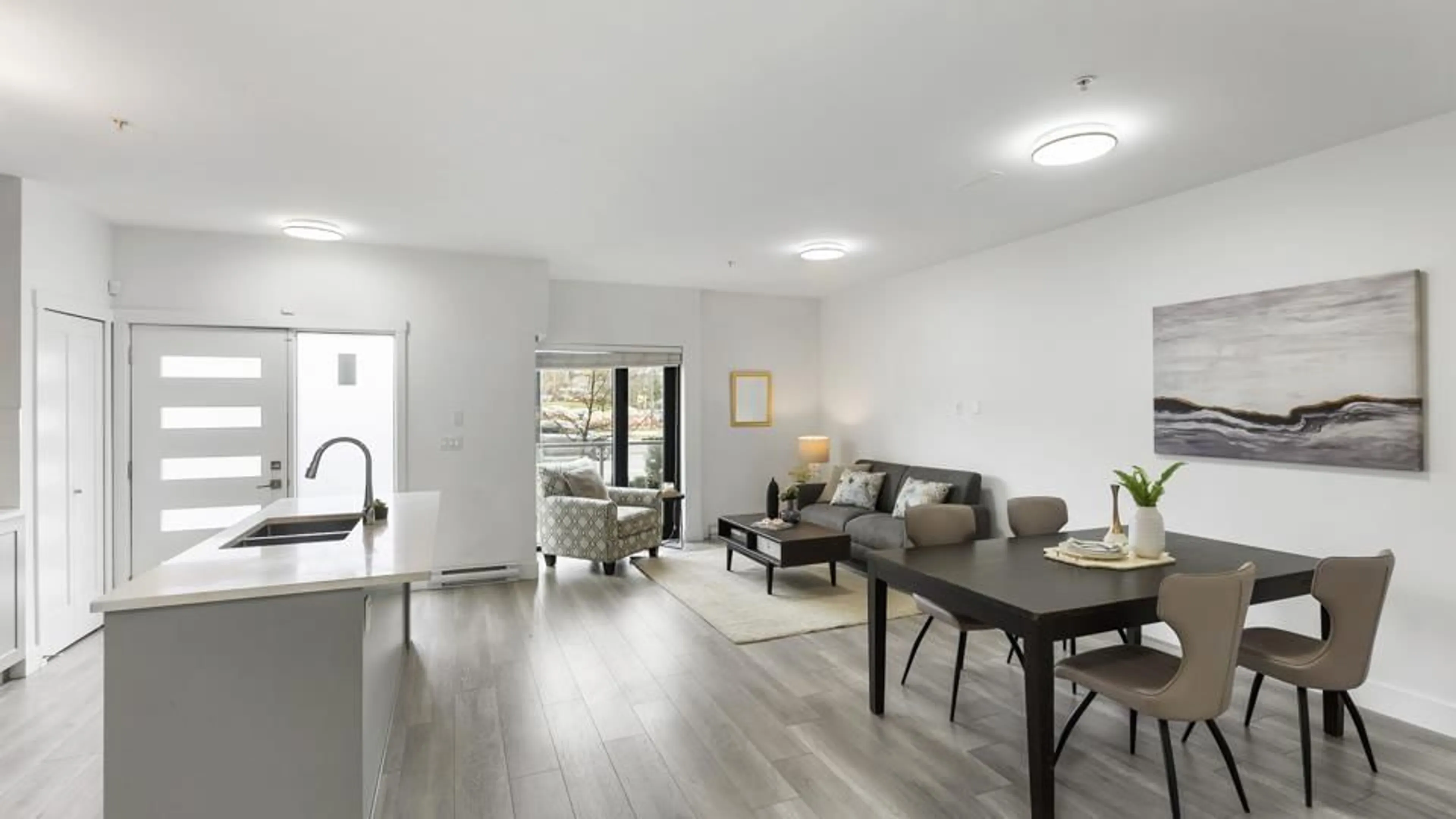 Living room with furniture, wood/laminate floor for 103 - 13978 FRASER, Surrey British Columbia V3T0P2