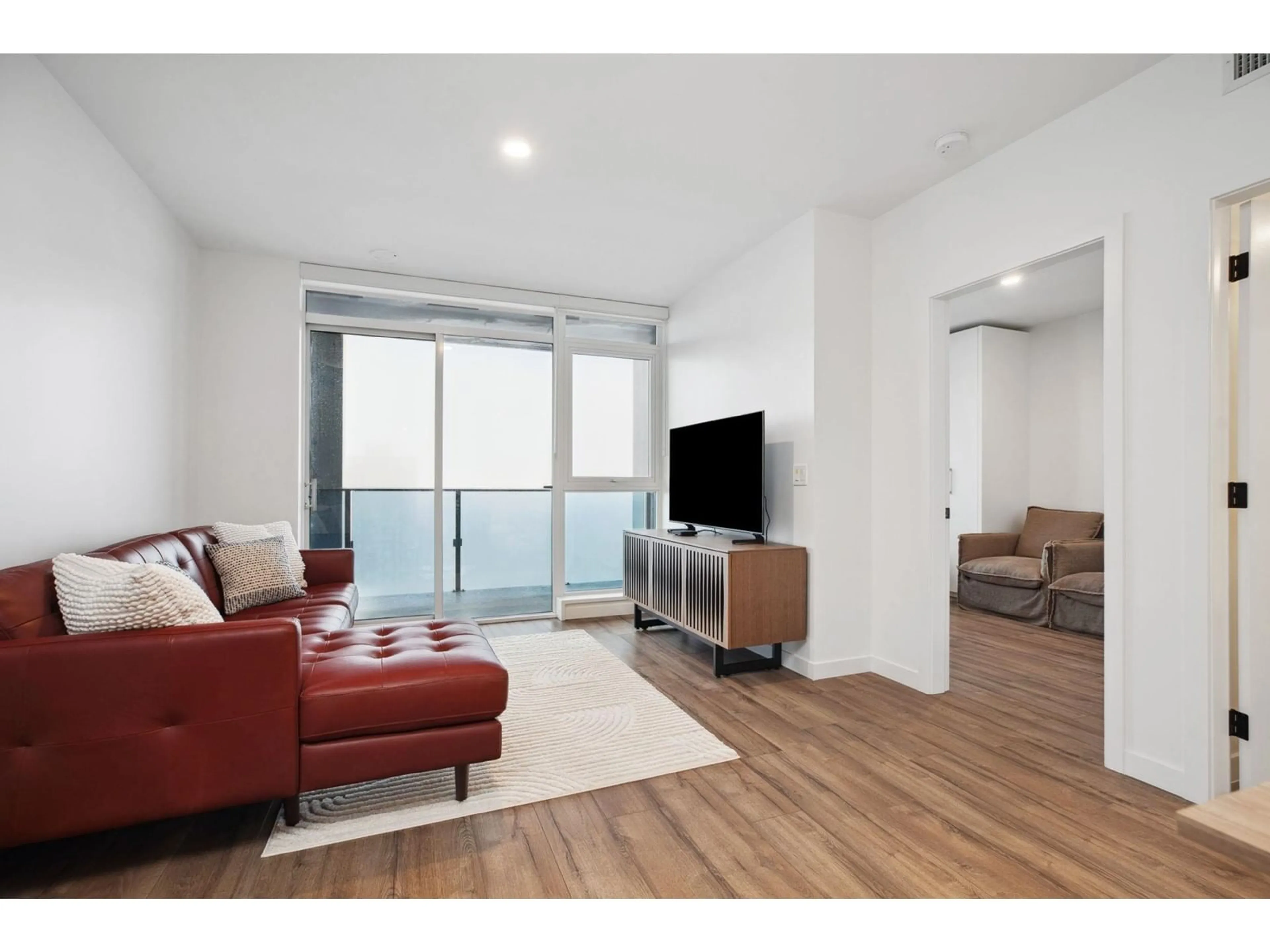 Living room with furniture, wood/laminate floor for 3609 - 10448 UNIVERSITY, Surrey British Columbia V3T0S7