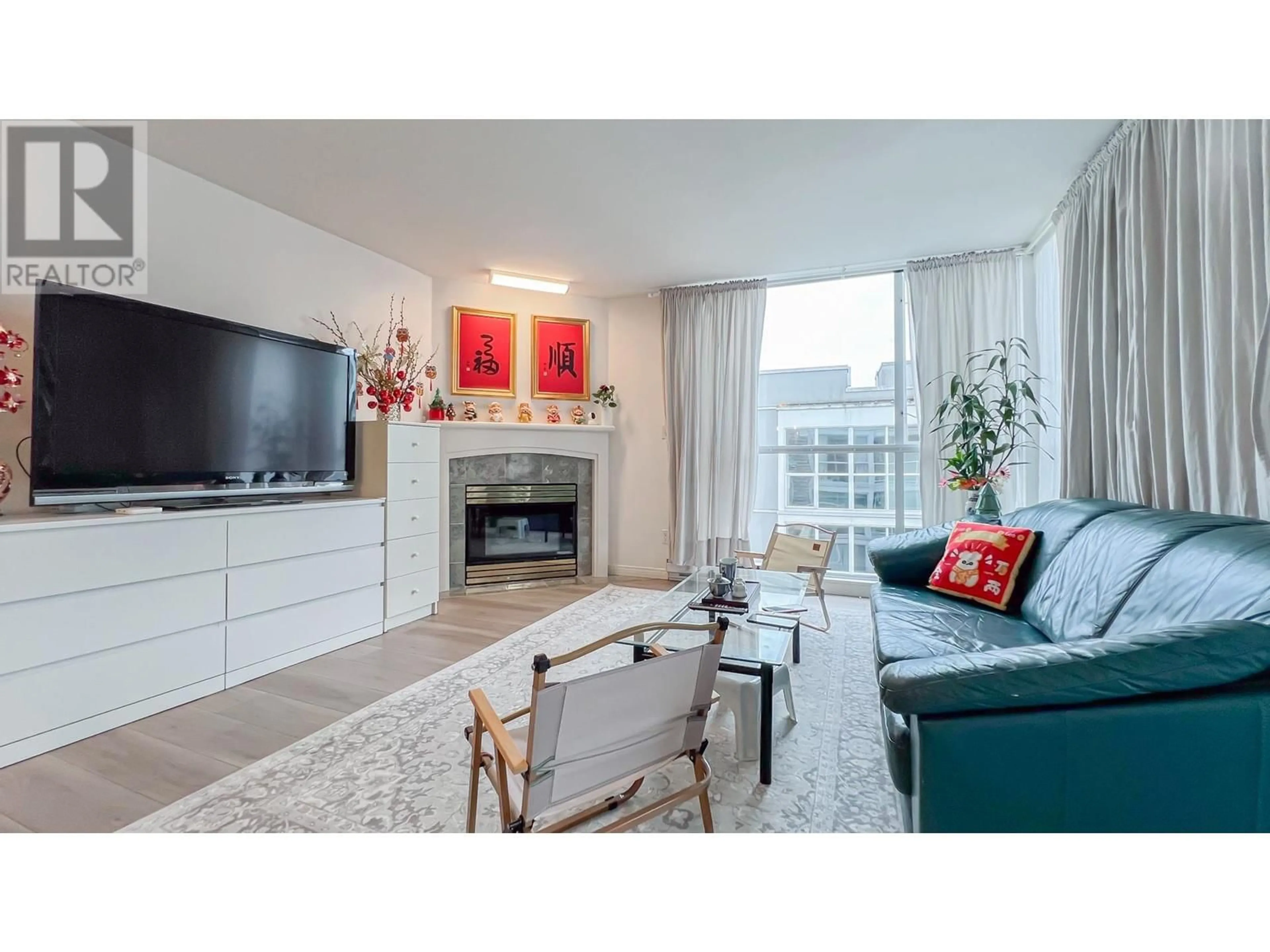 Living room with furniture, wood/laminate floor for 205 - 8430 JELLICOE STREET, Vancouver British Columbia V5S4S7