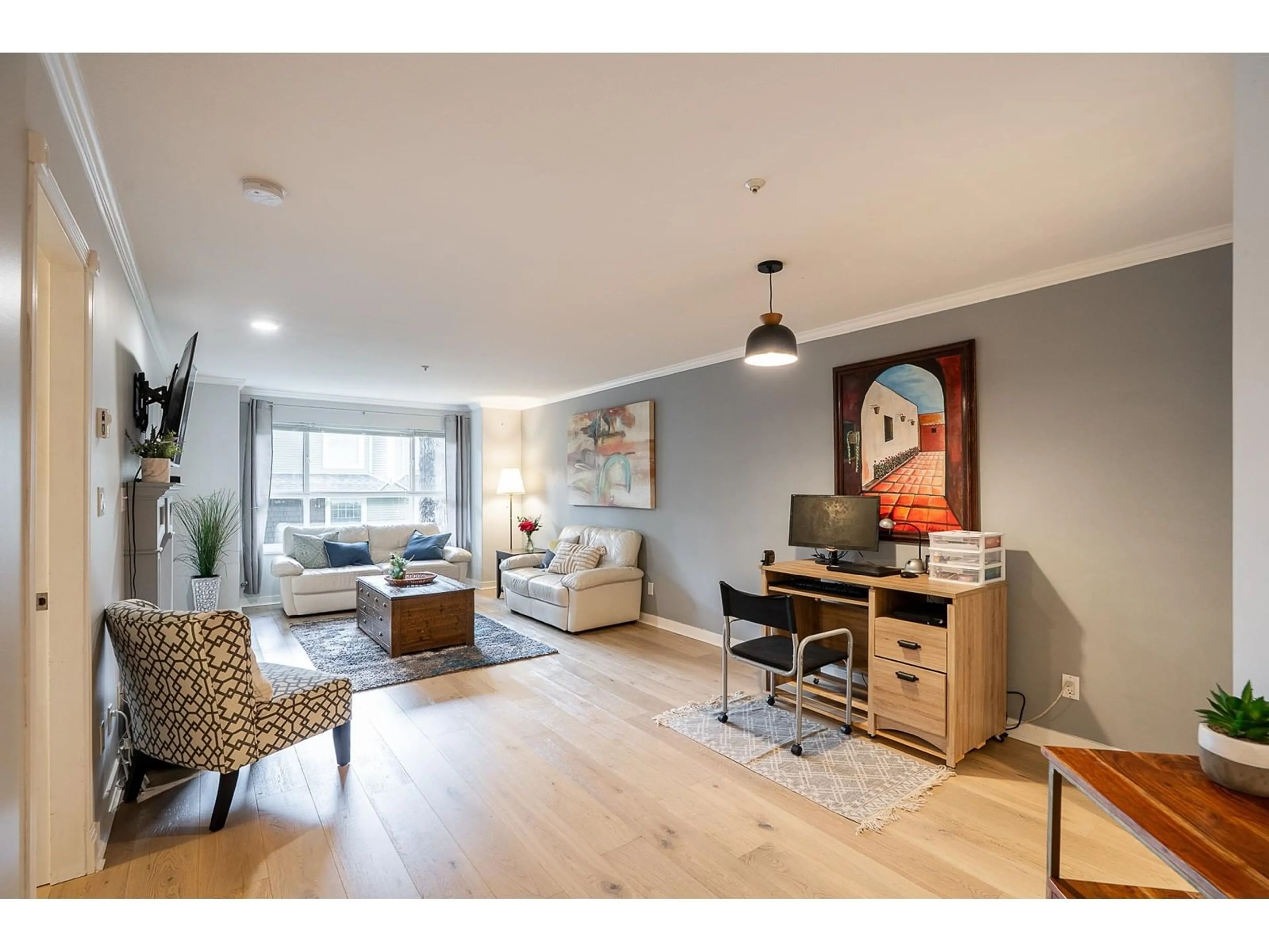 Living room with furniture, wood/laminate floor for 106 - 9018 208, Langley British Columbia V1M2Y8