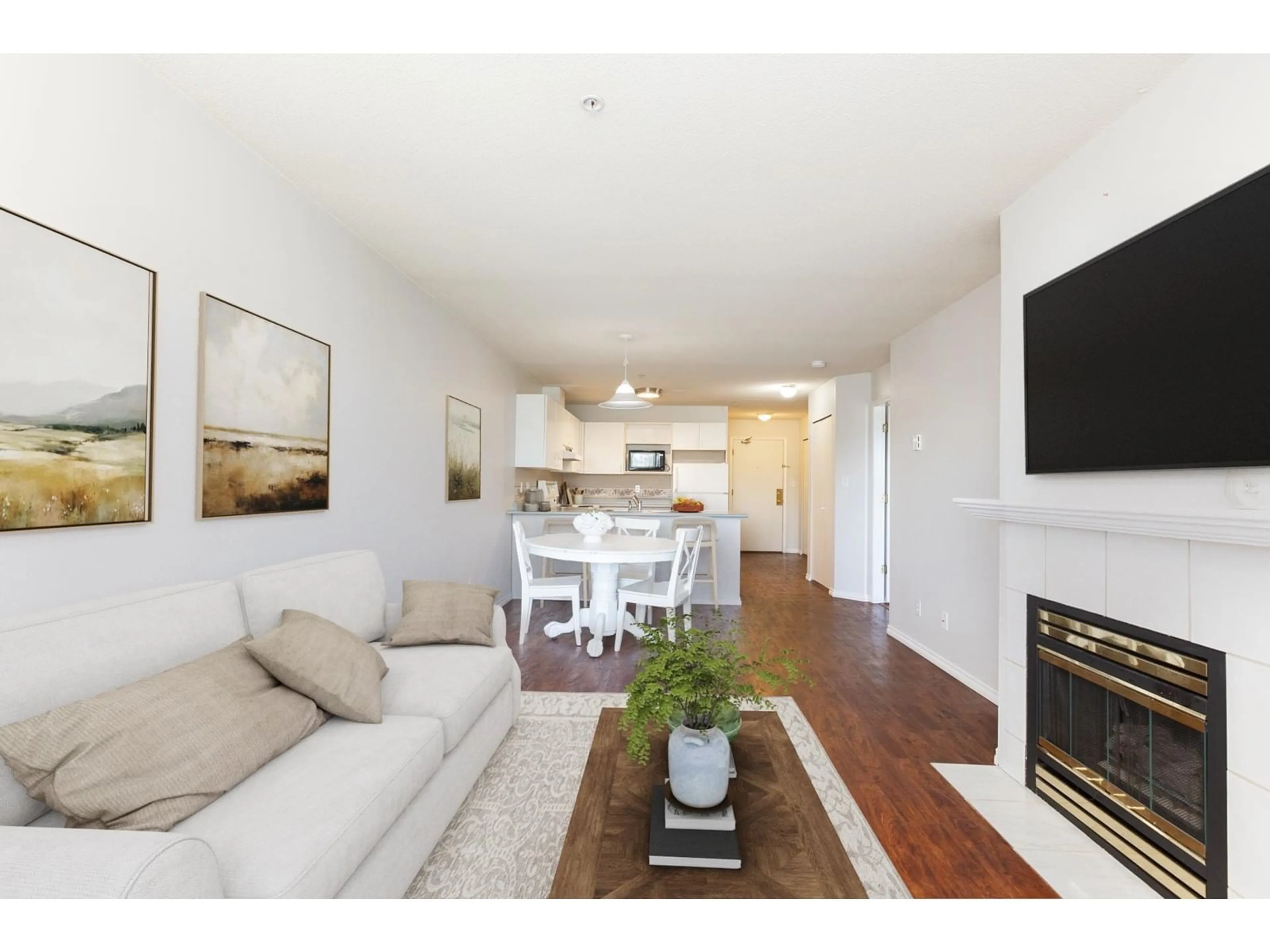 Living room with furniture, wood/laminate floor for 409 - 12130 80TH, Surrey British Columbia V3W0V2