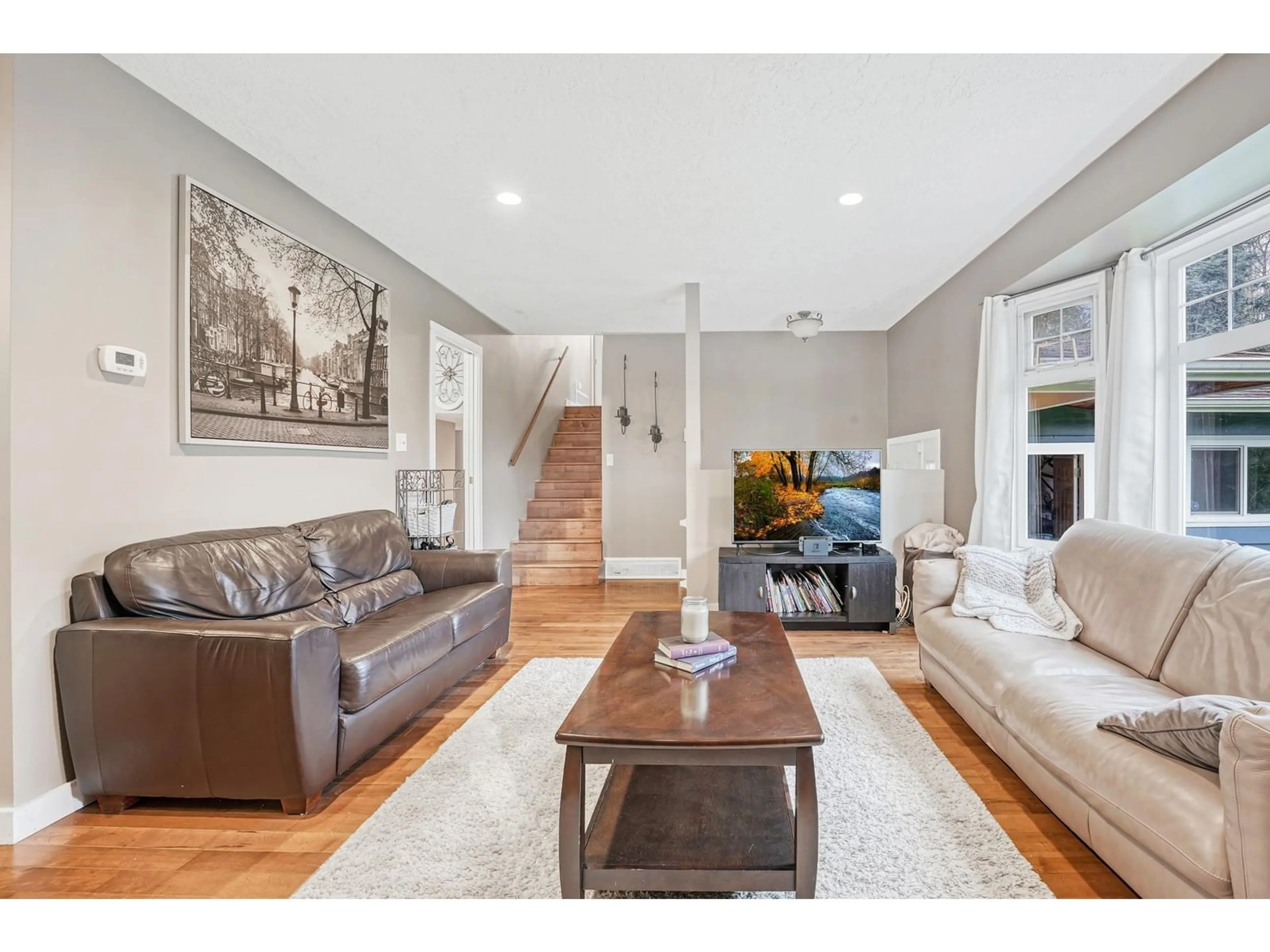 Living room with furniture, wood/laminate floor for 2488 CAMERON, Abbotsford British Columbia V3G2A9