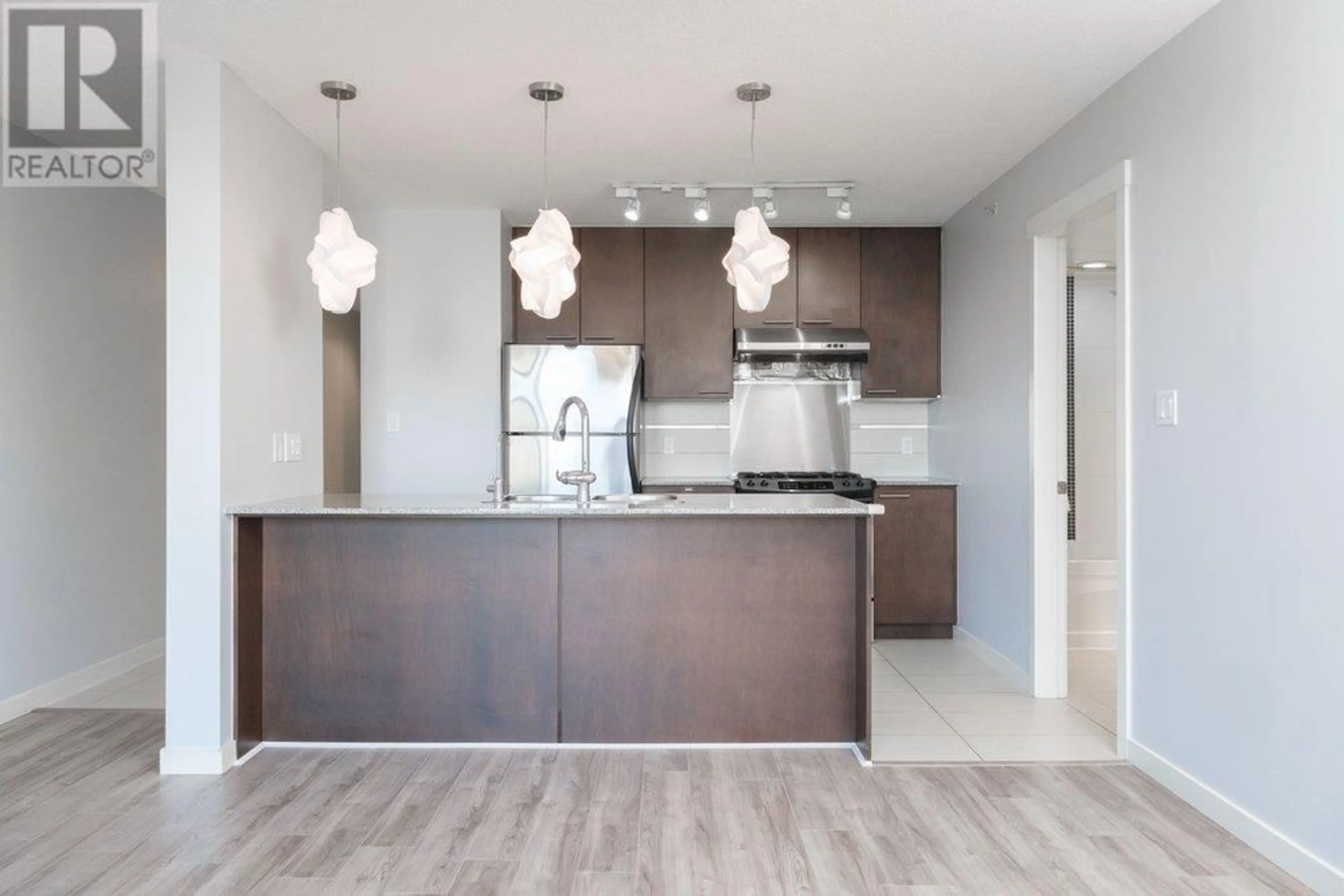 Open concept kitchen, wood/laminate floor for 713 - 5811 NO. 3 ROAD, Richmond British Columbia V6X4L7