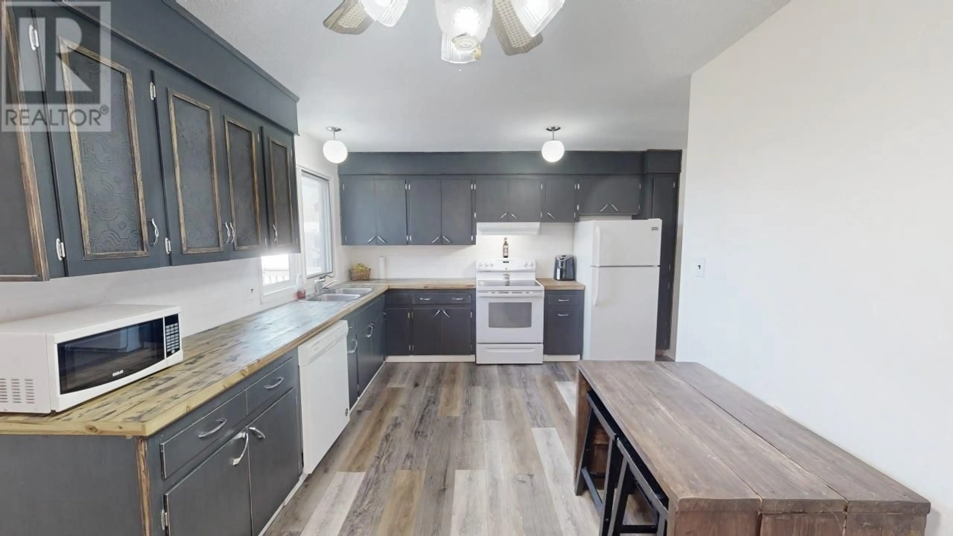 Open concept kitchen, wood/laminate floor for 6365 MARIGOLD AVENUE, Fort St. John British Columbia V1J8B6