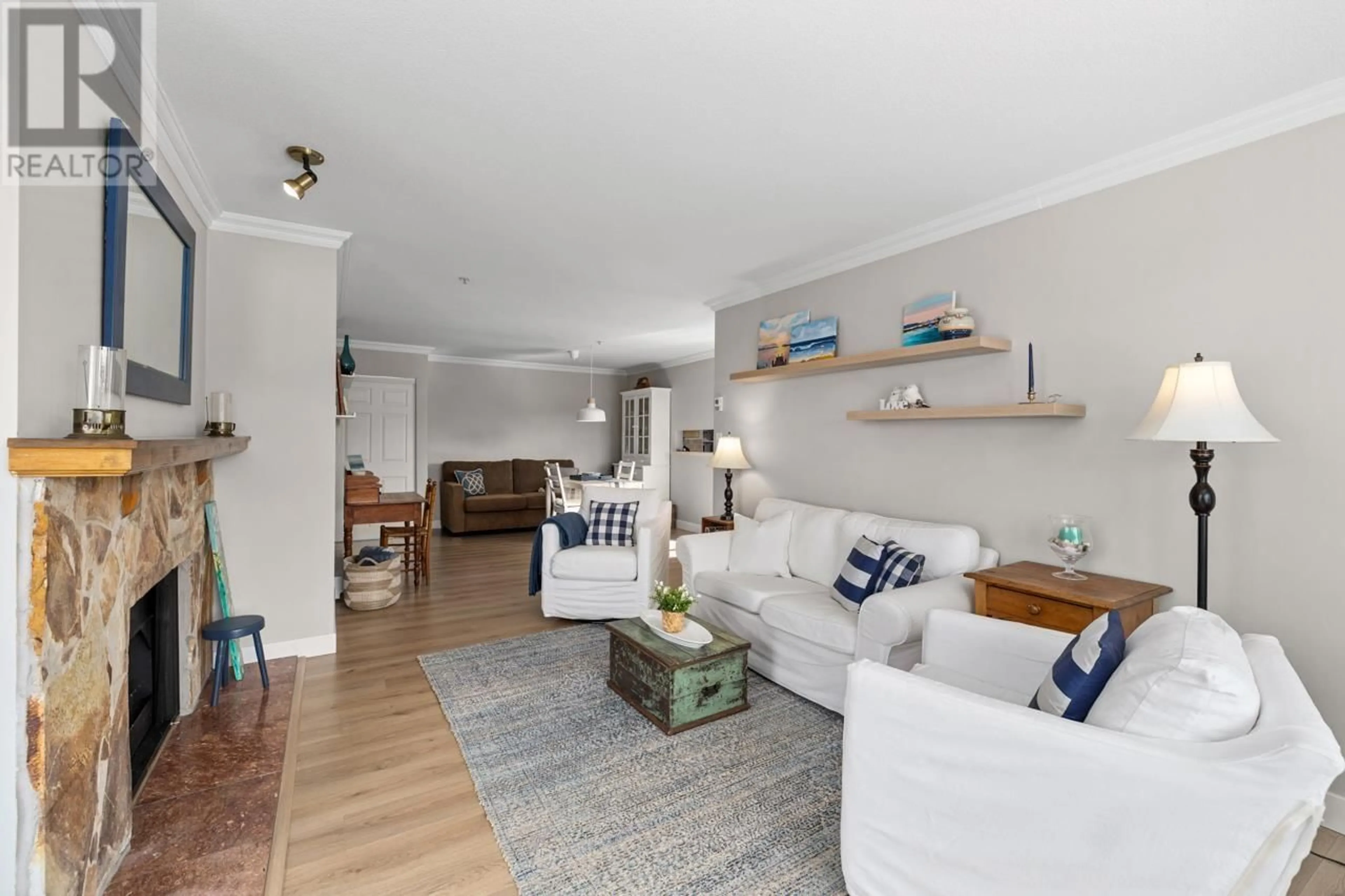 Living room with furniture, wood/laminate floor for 610 - 1000 BOWRON COURT, North Vancouver British Columbia V7H2W1