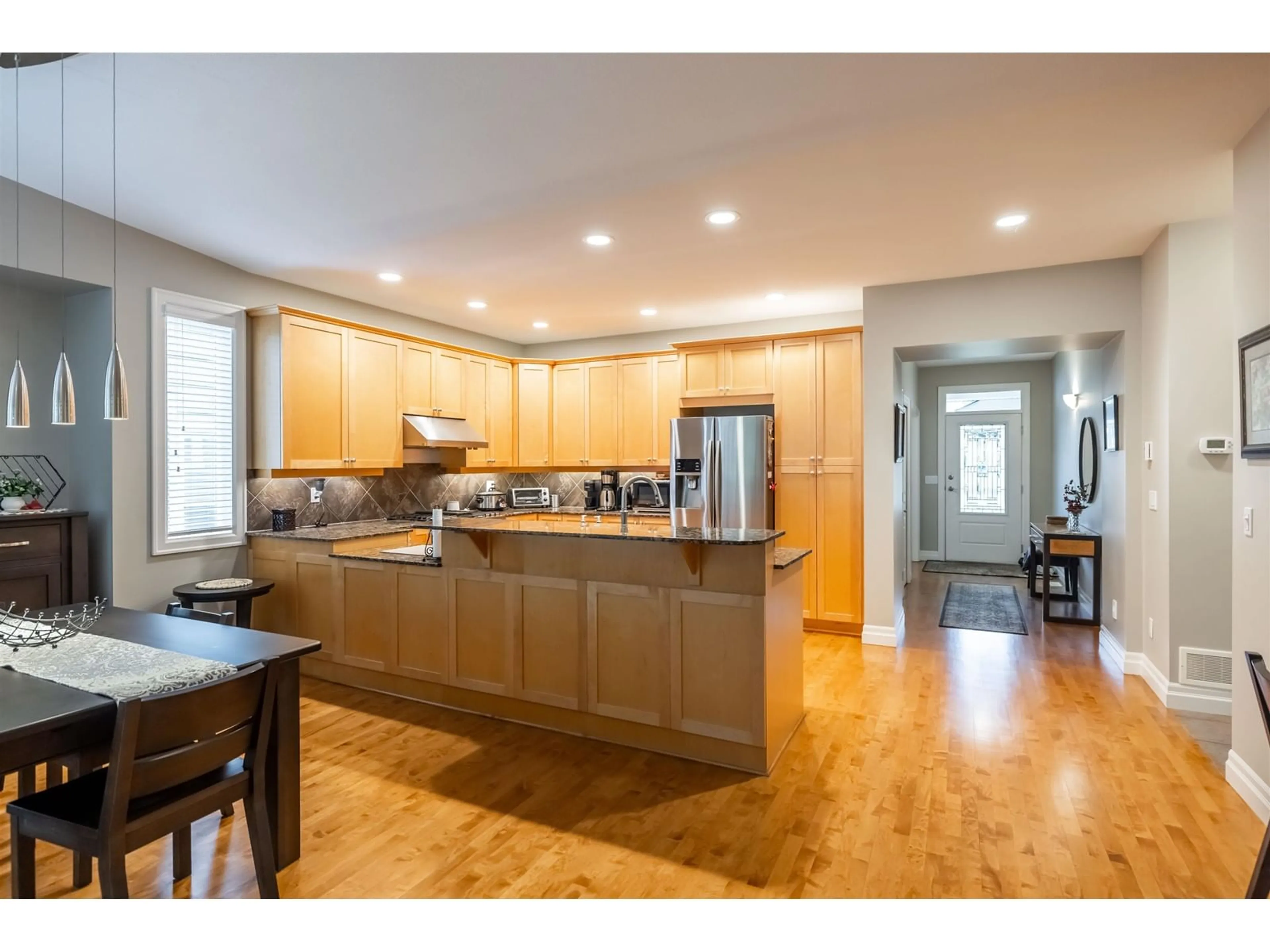 Open concept kitchen, wood/laminate floor for 20426 67A, Langley British Columbia V2Y2X5