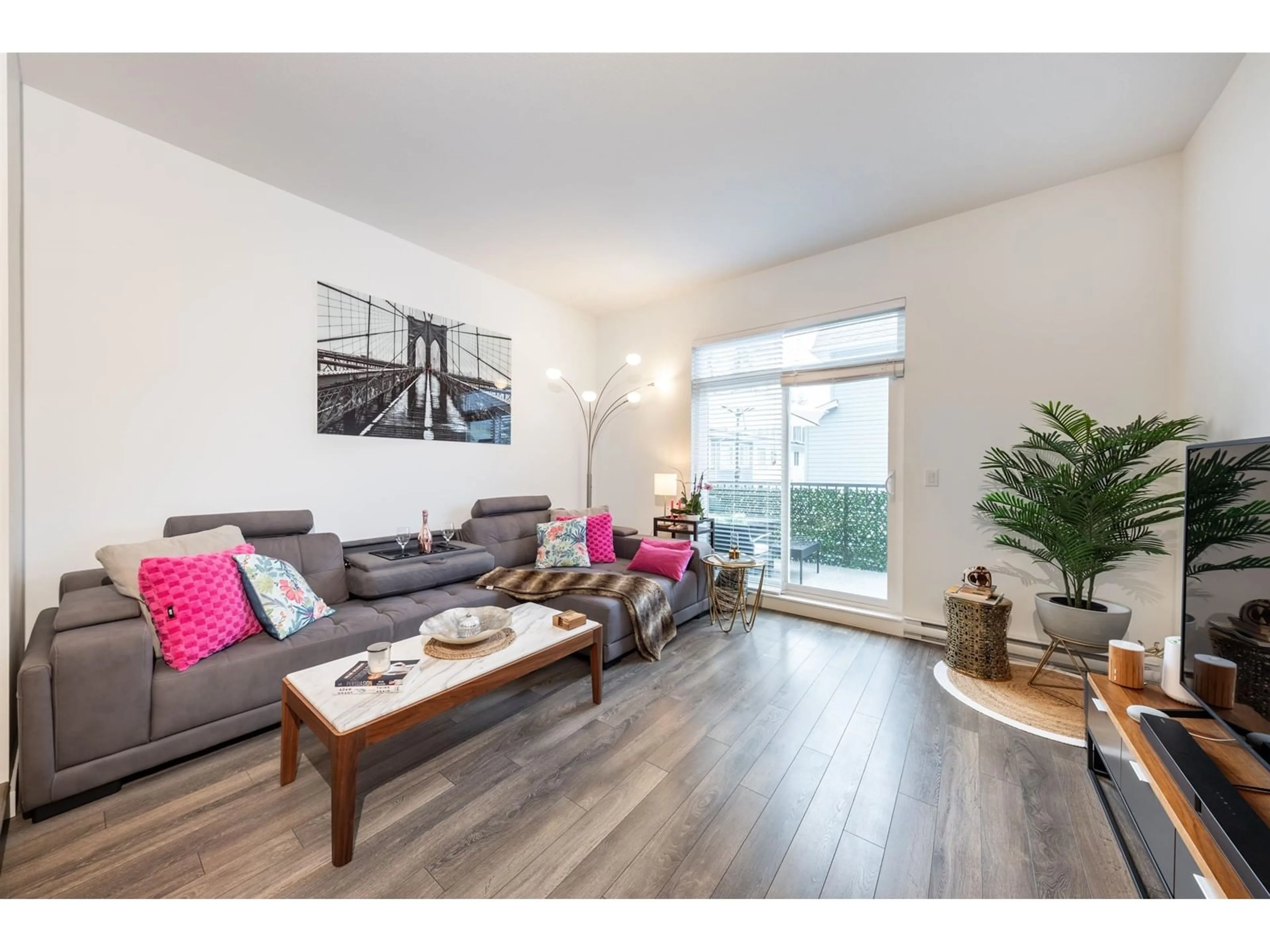 Living room with furniture, wood/laminate floor for 85 - 158 171, Surrey British Columbia V3Z0X1