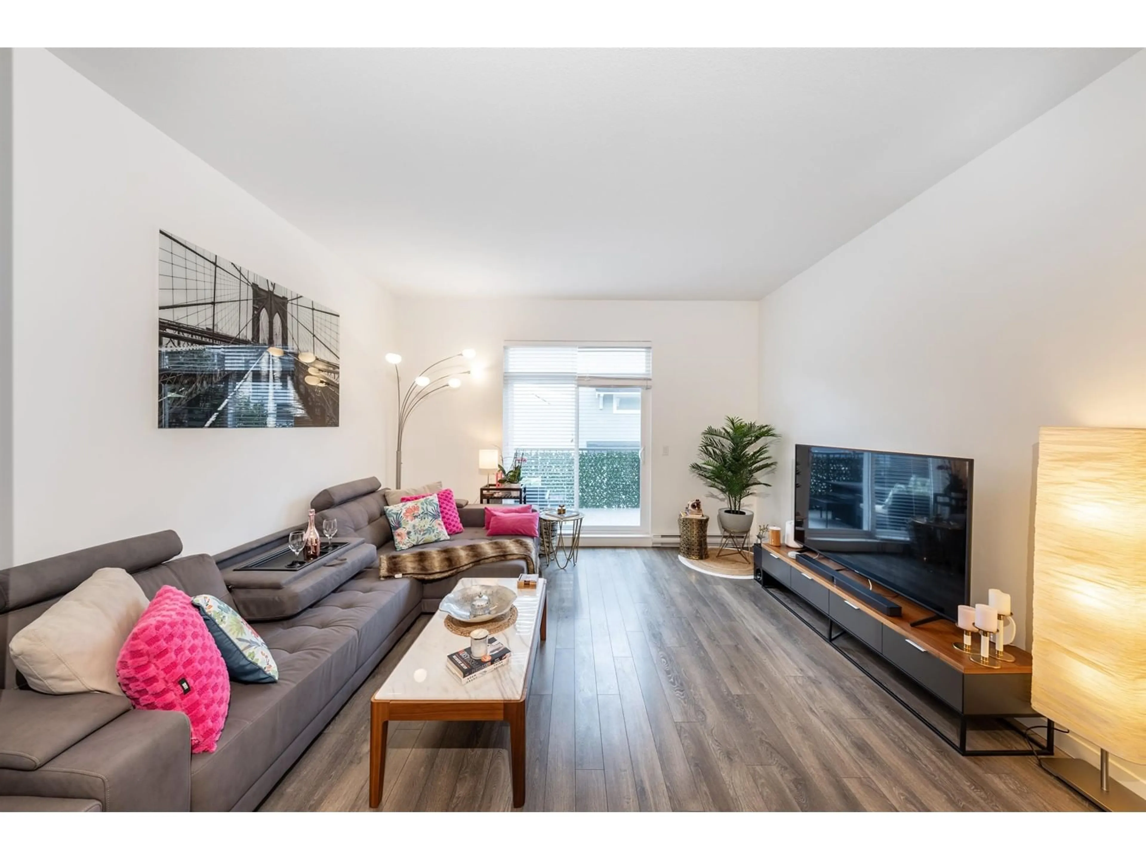 Living room with furniture, wood/laminate floor for 85 - 158 171, Surrey British Columbia V3Z0X1