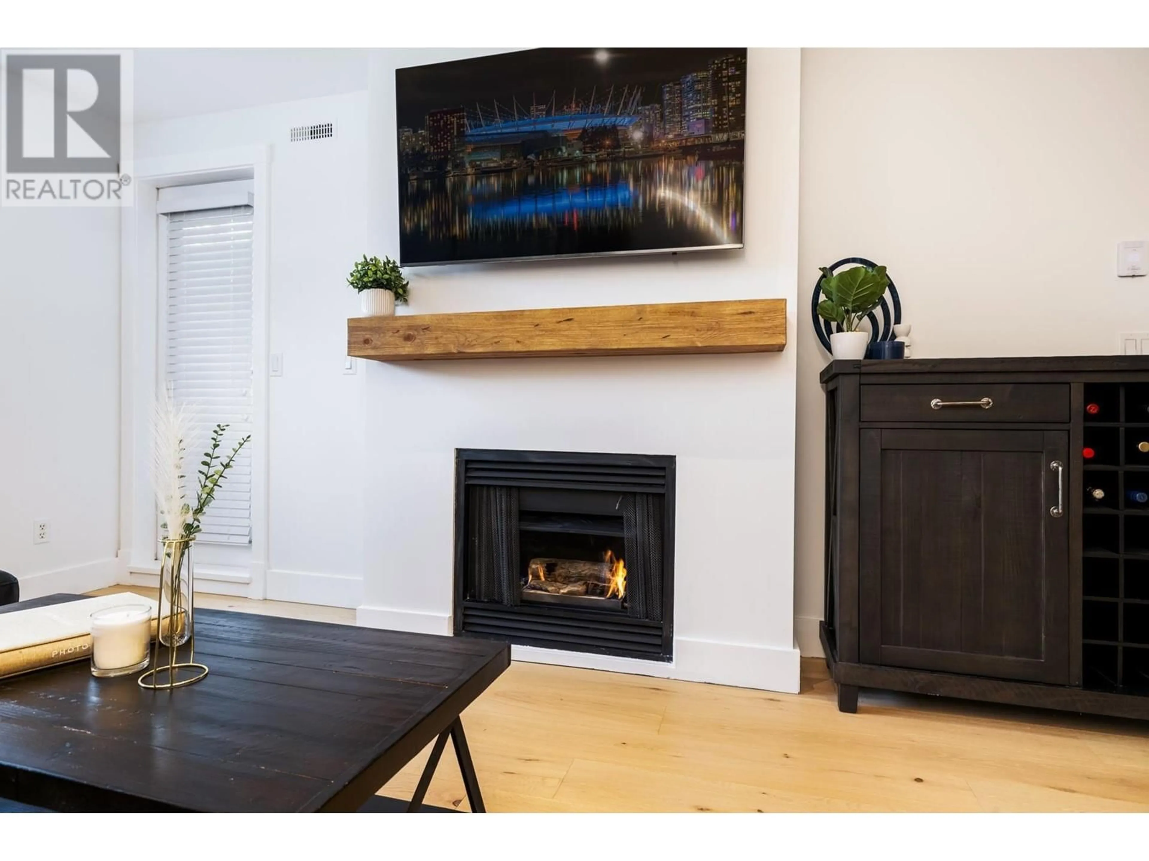 Living room with furniture, wood/laminate floor for 204 - 1111 LYNN VALLEY ROAD, North Vancouver British Columbia V7J3V4