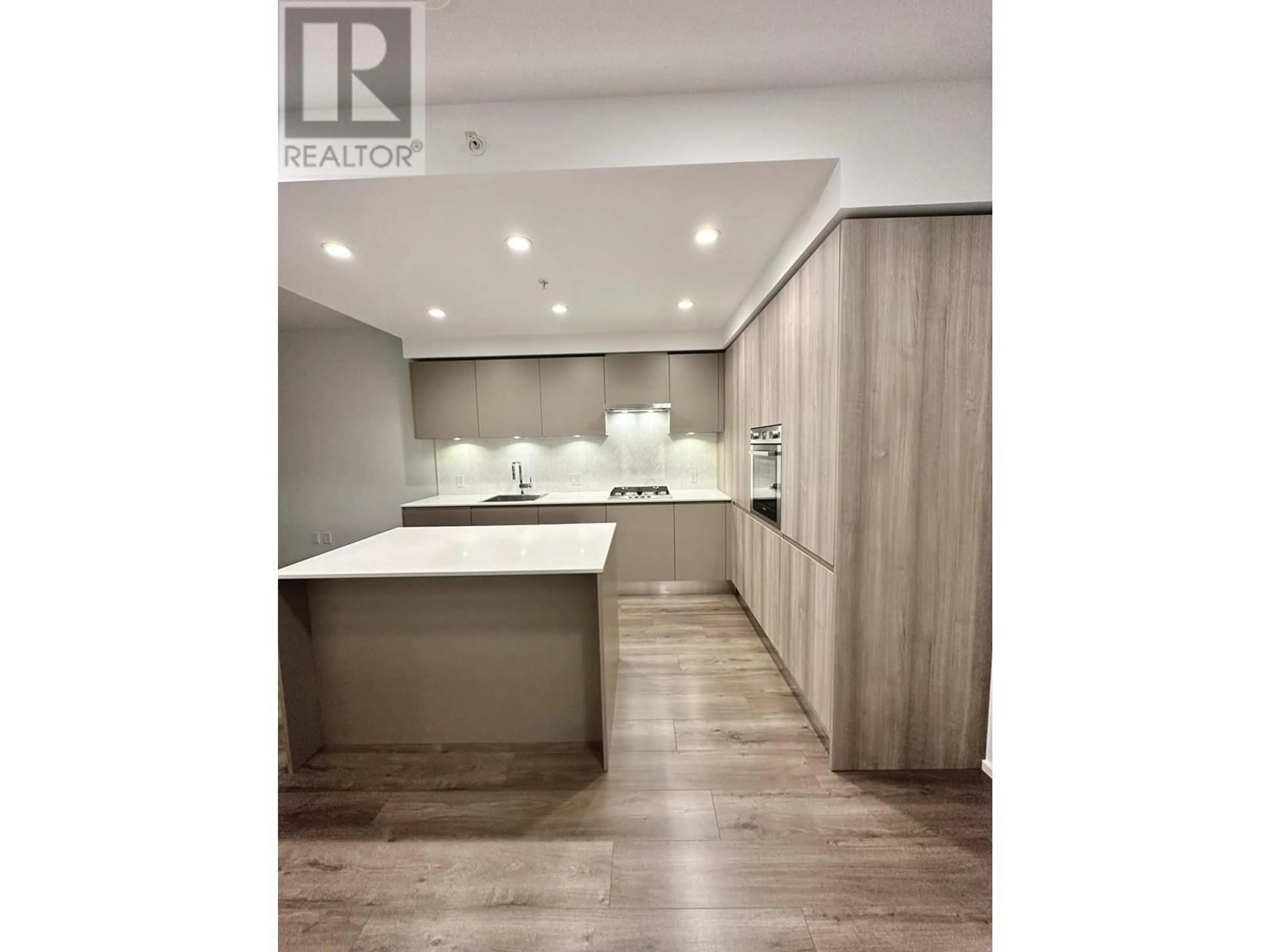 Open concept kitchen, wood/laminate floor for 309 - 3833 EVERGREEN PLACE, Burnaby British Columbia V3J0M2